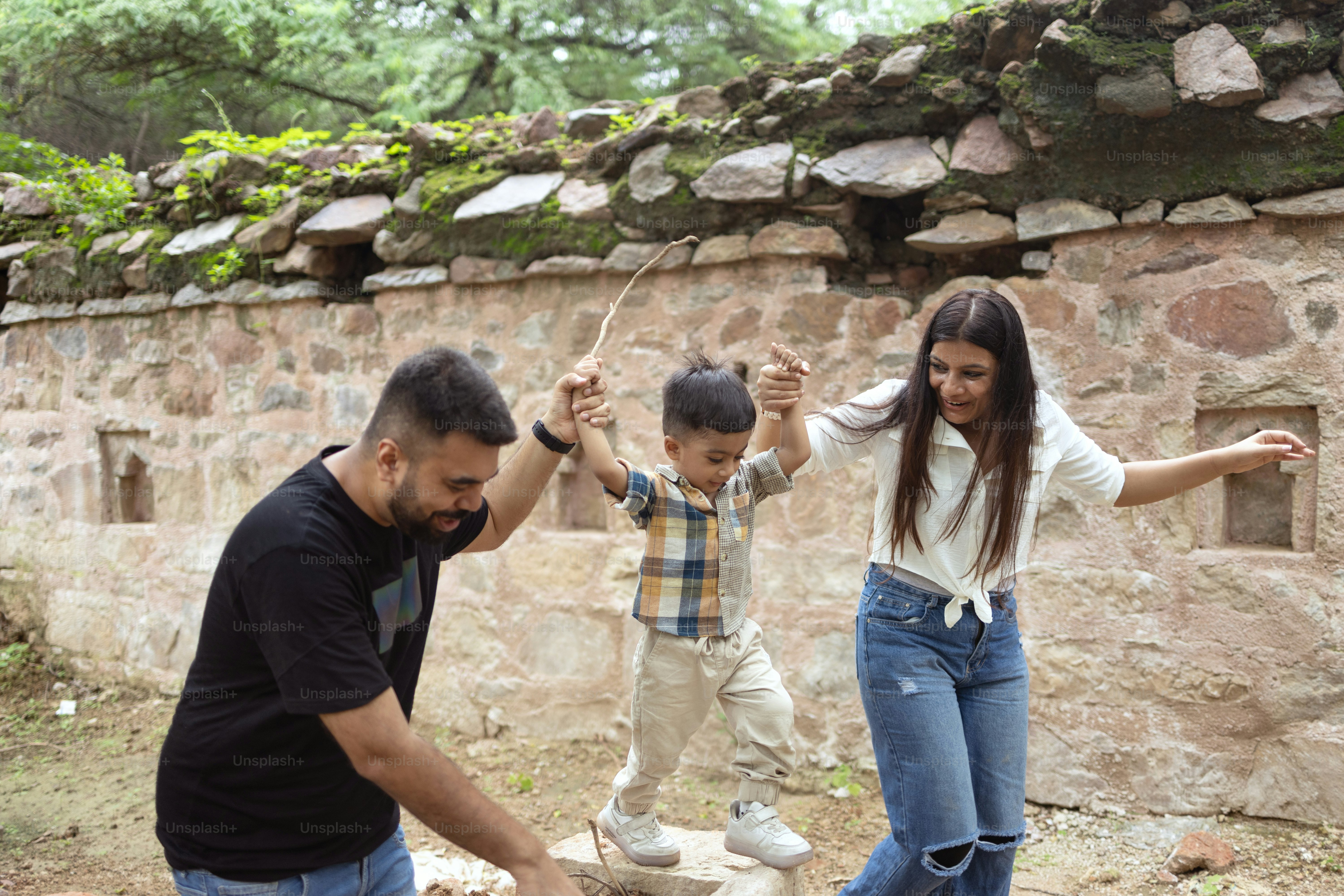A group of people standing around a stone wall
