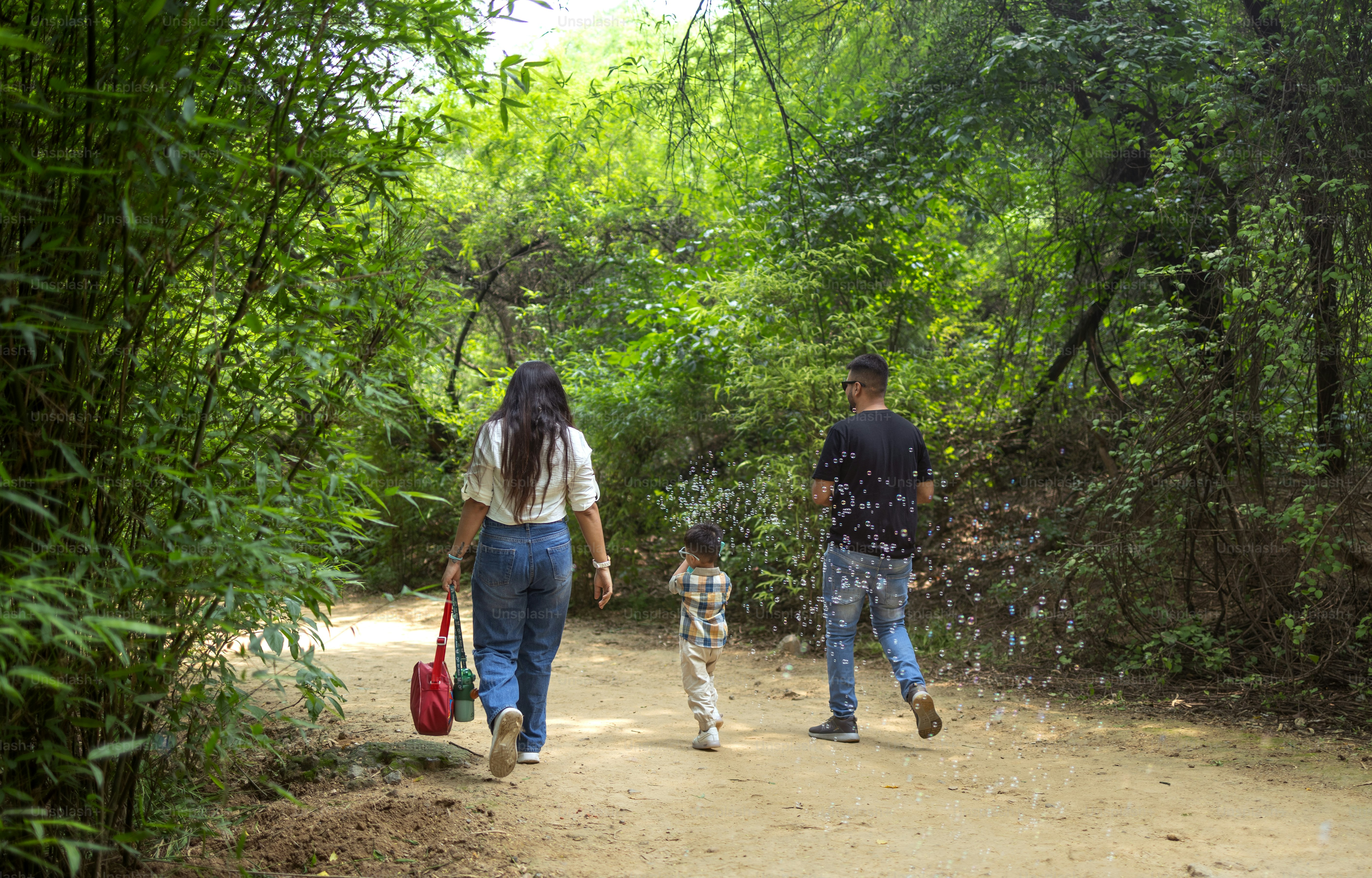 A man and a woman walking down a dirt road