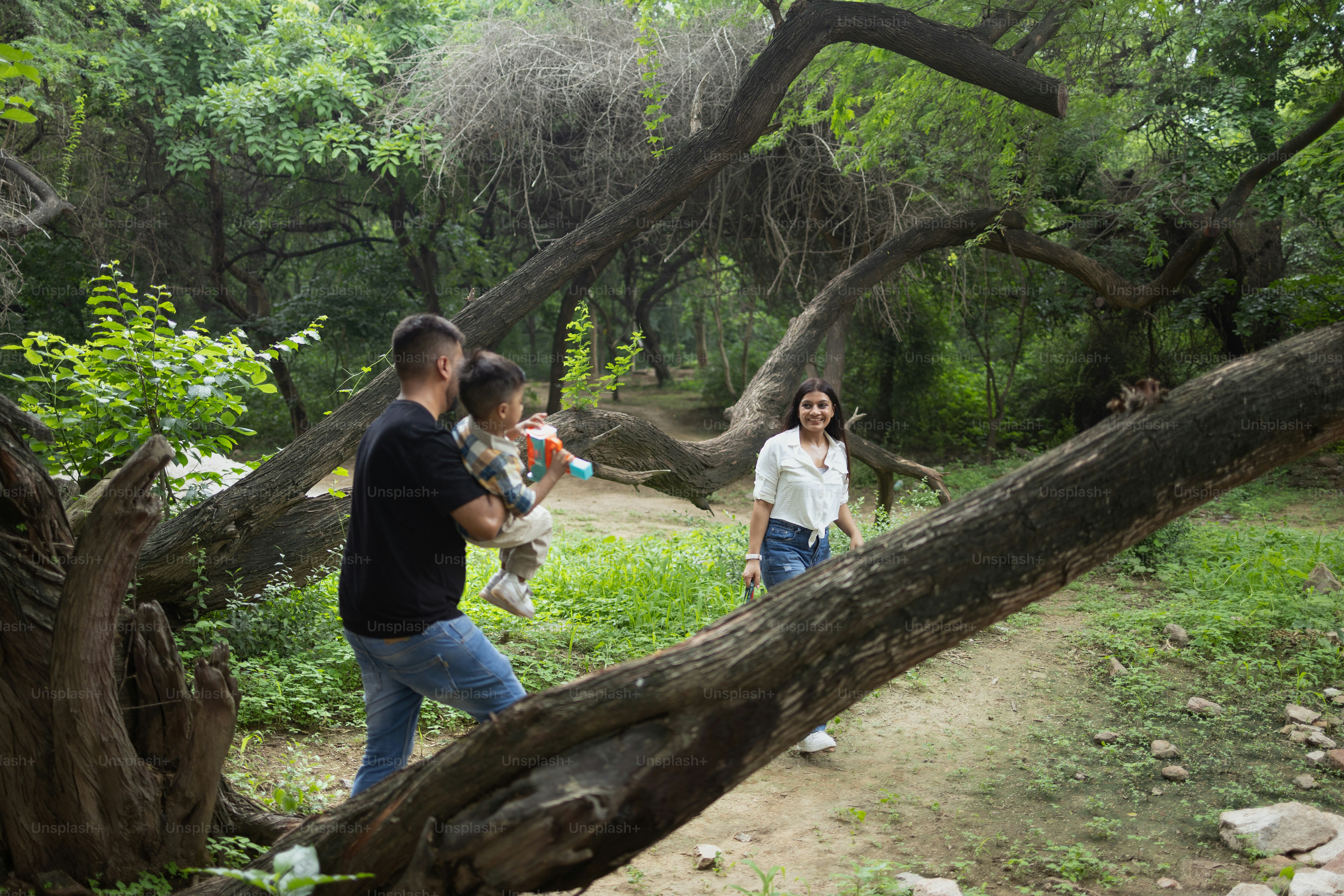 A group of people walking through a forest