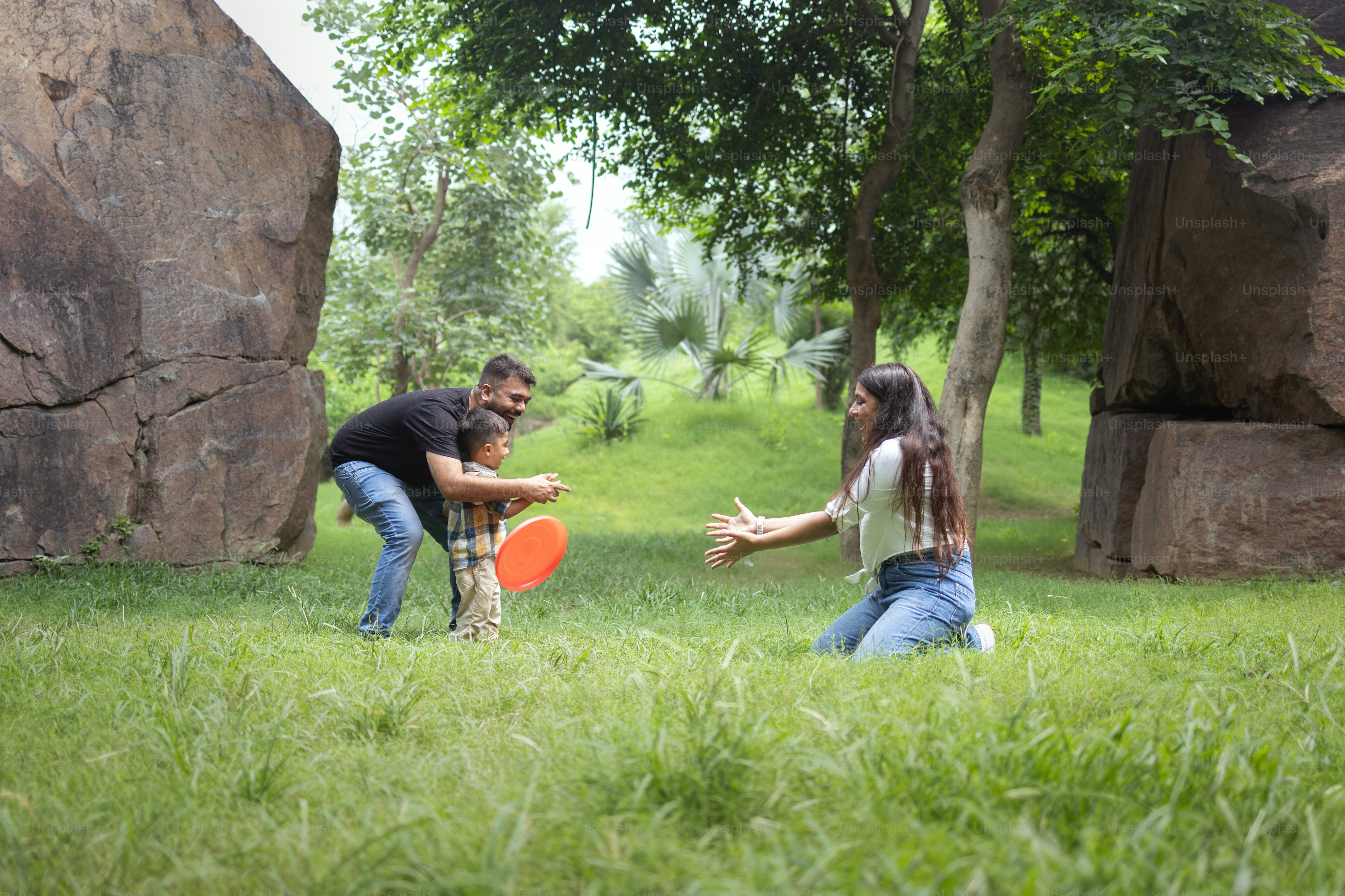 A man and a woman playing frisbee in a park