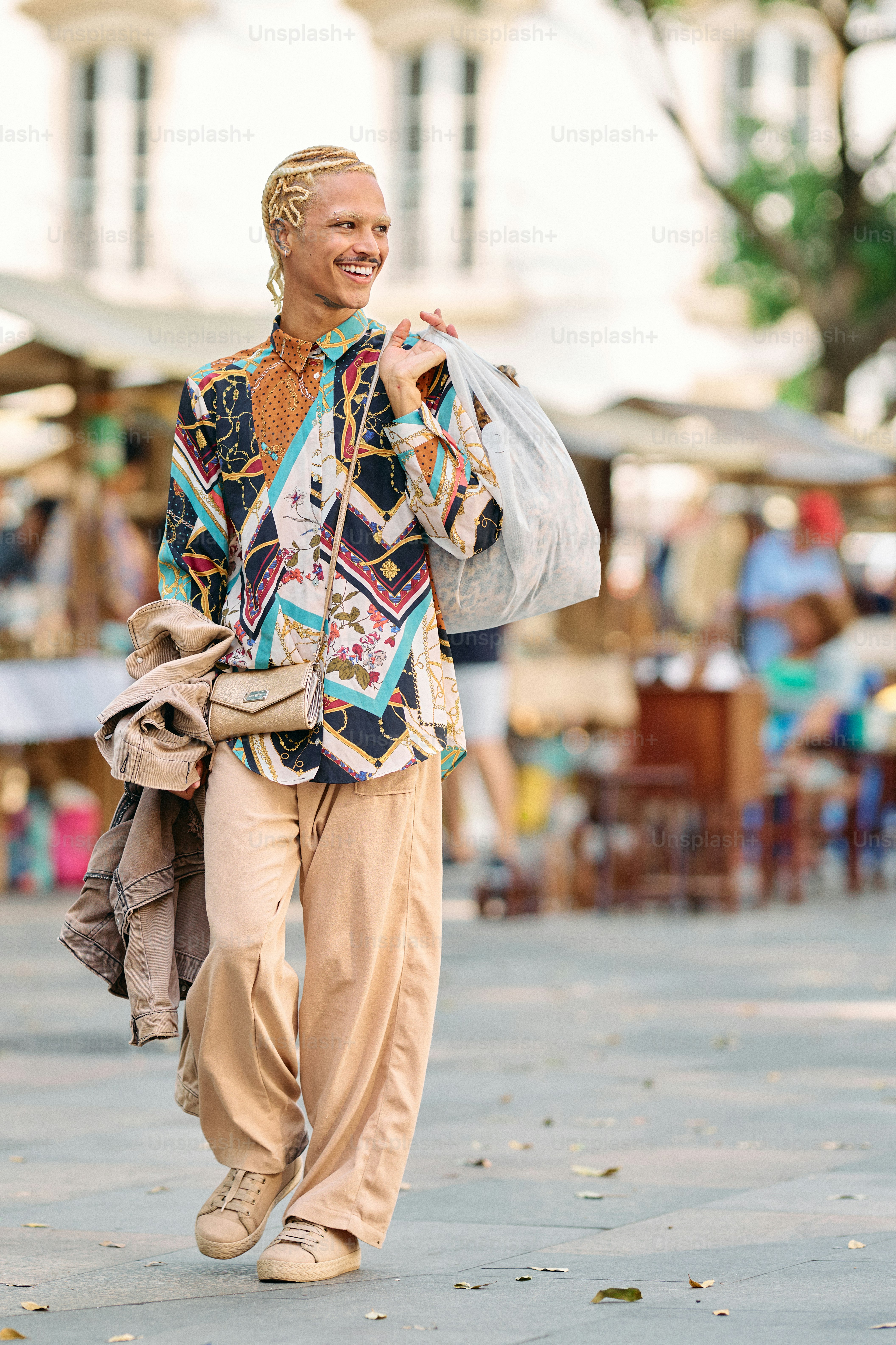 A woman walking down a street carrying a bag