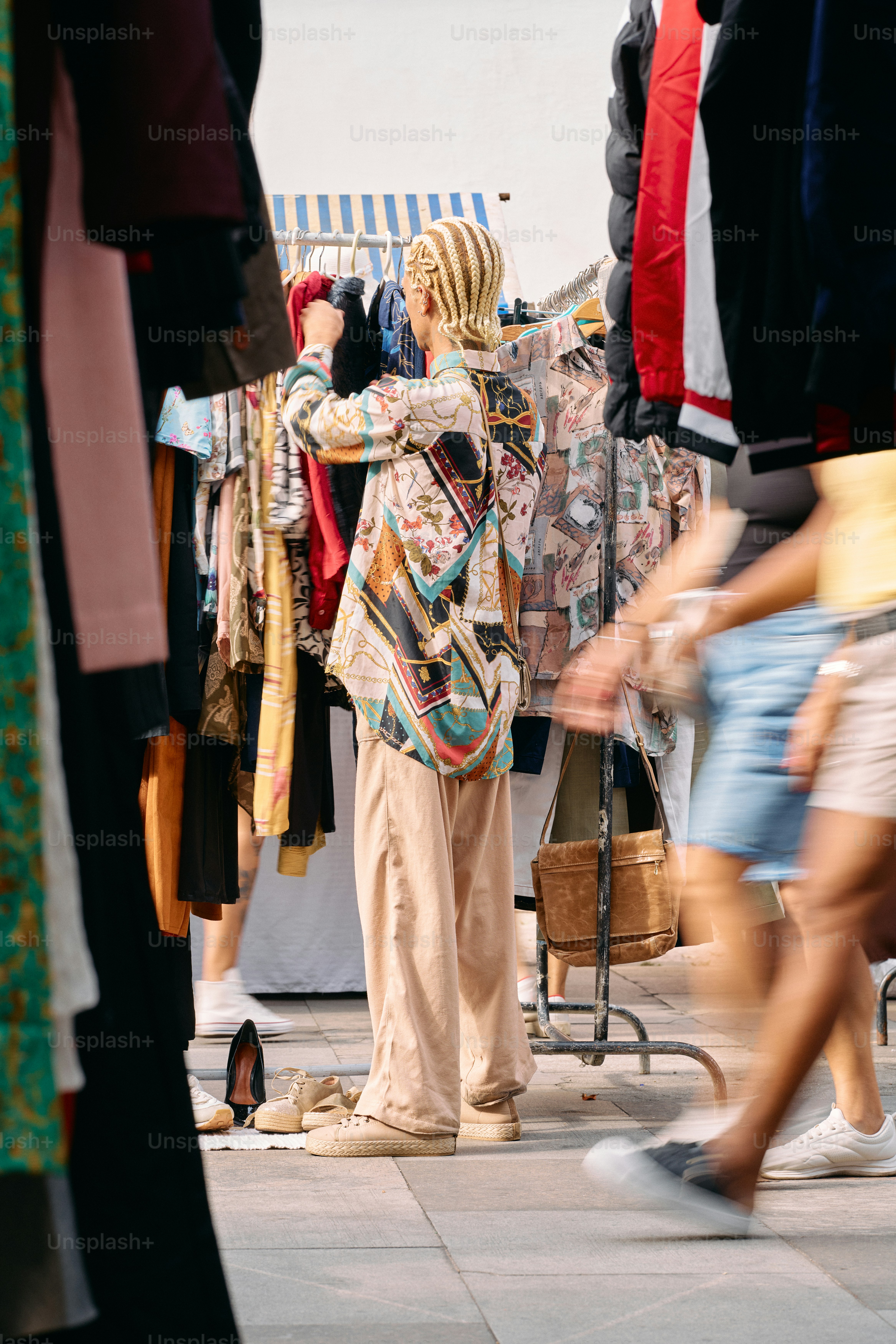 A woman standing in front of a rack of clothes
