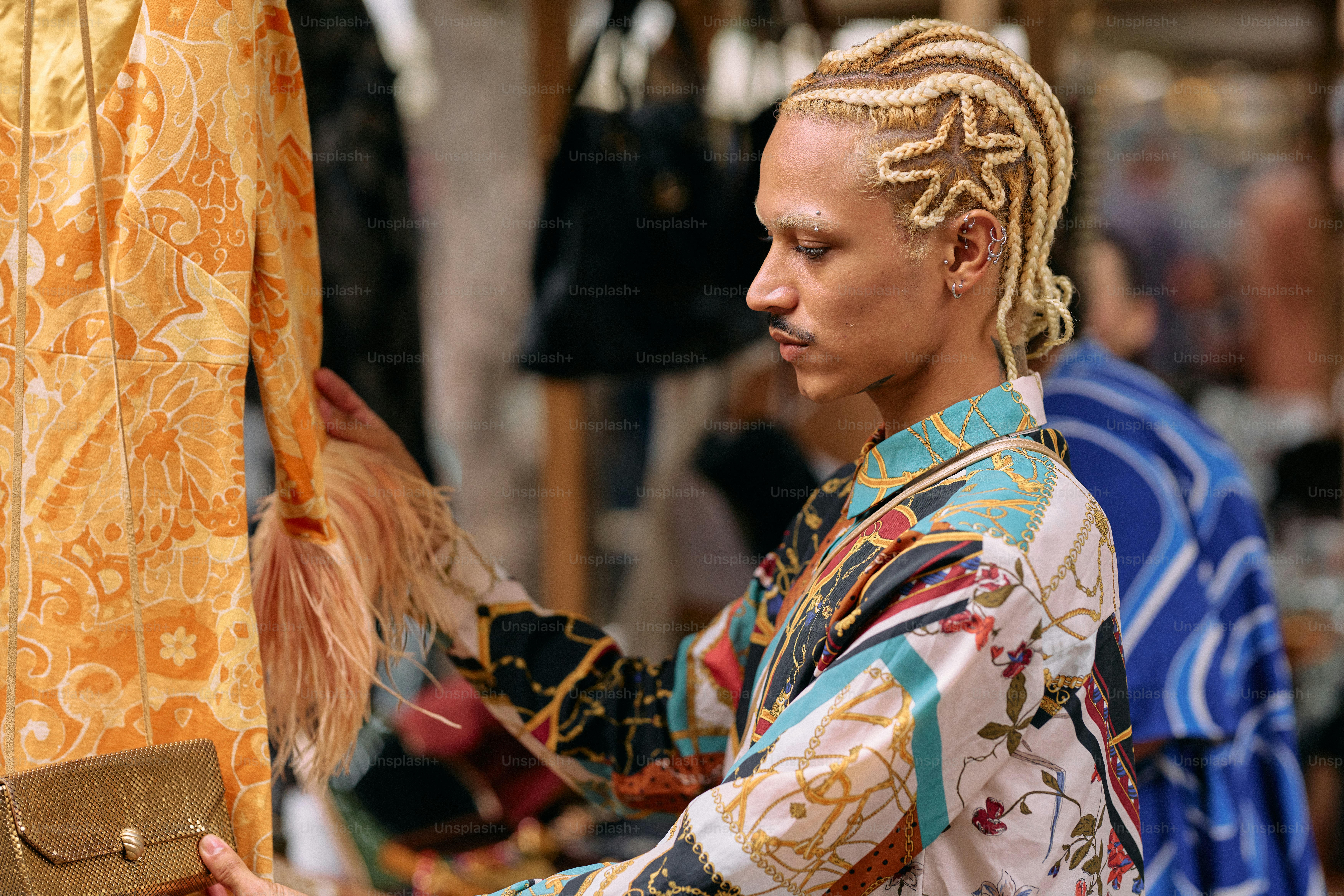 A man with dreadlocks standing in front of a cross