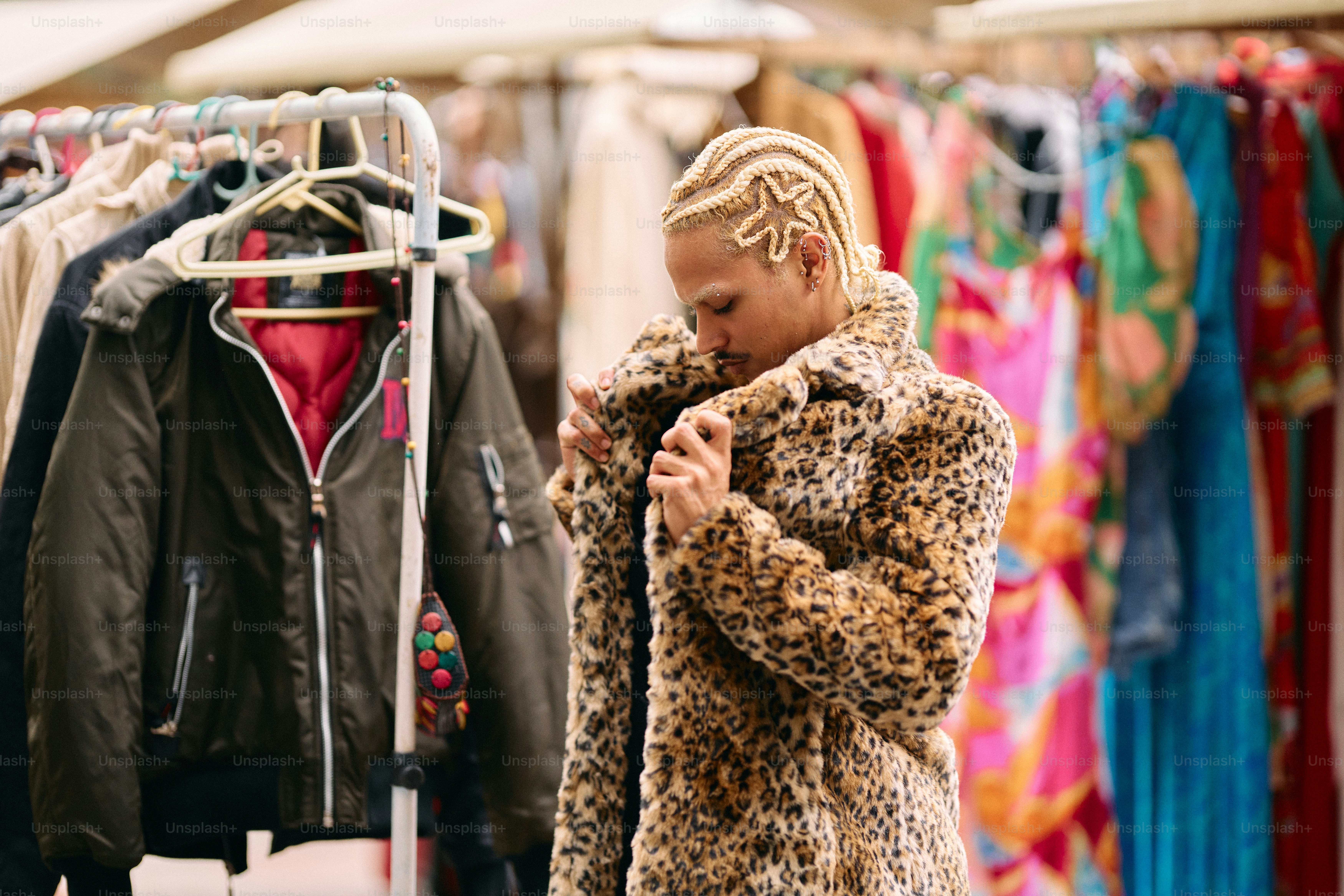 A woman standing in front of a rack of clothes