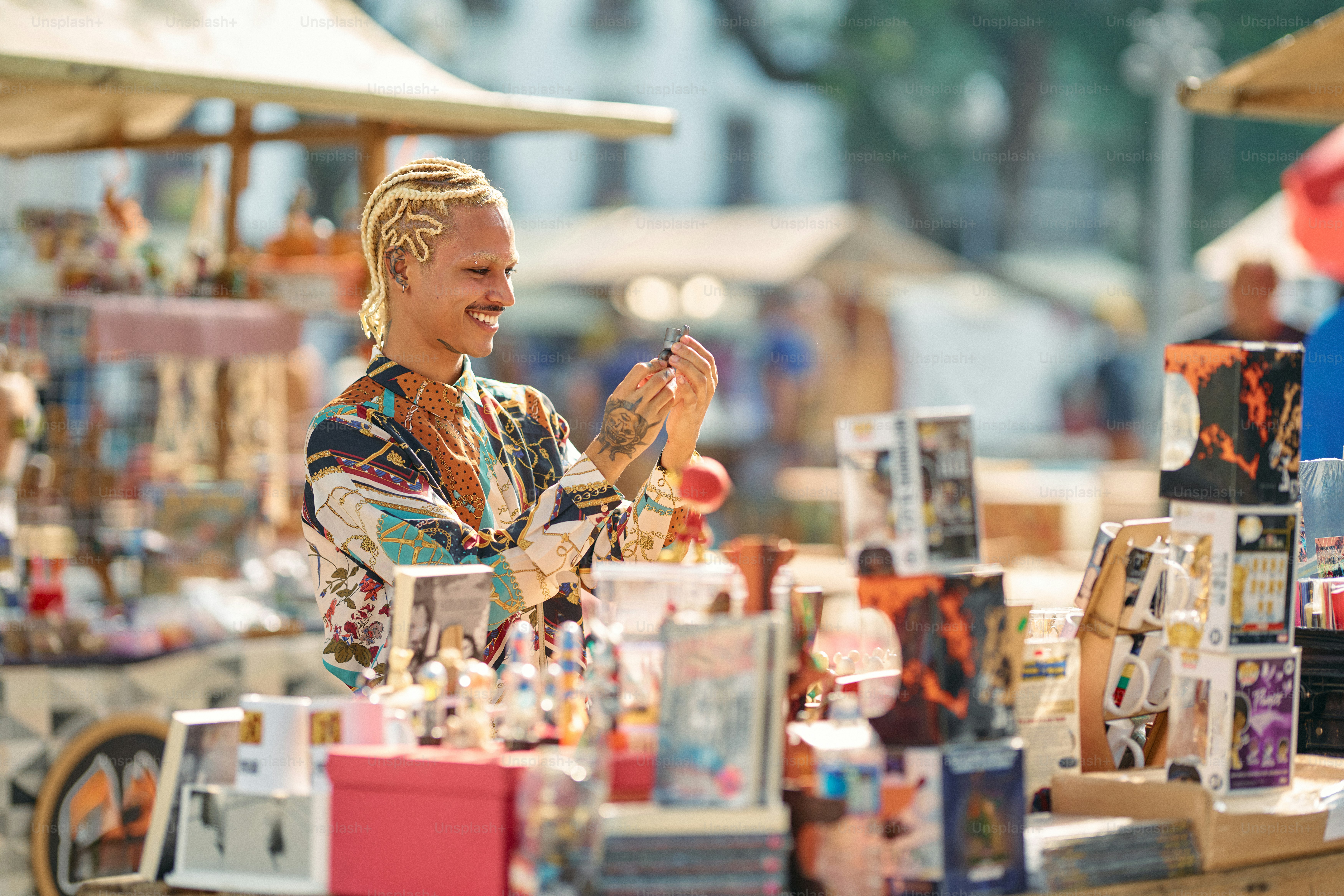 A man standing in front of a table filled with books