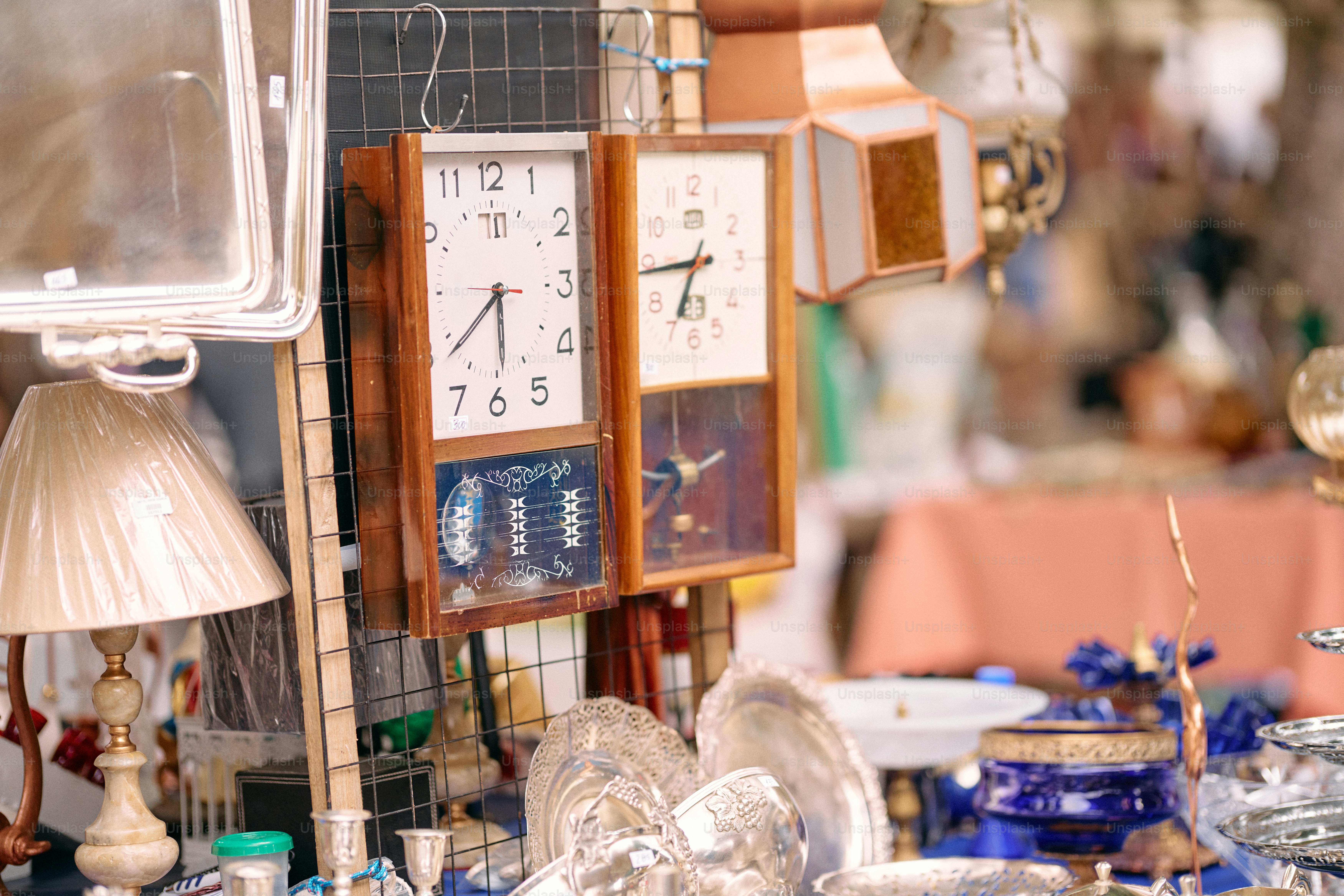 A table topped with lots of different types of clocks photo – Fashion ...