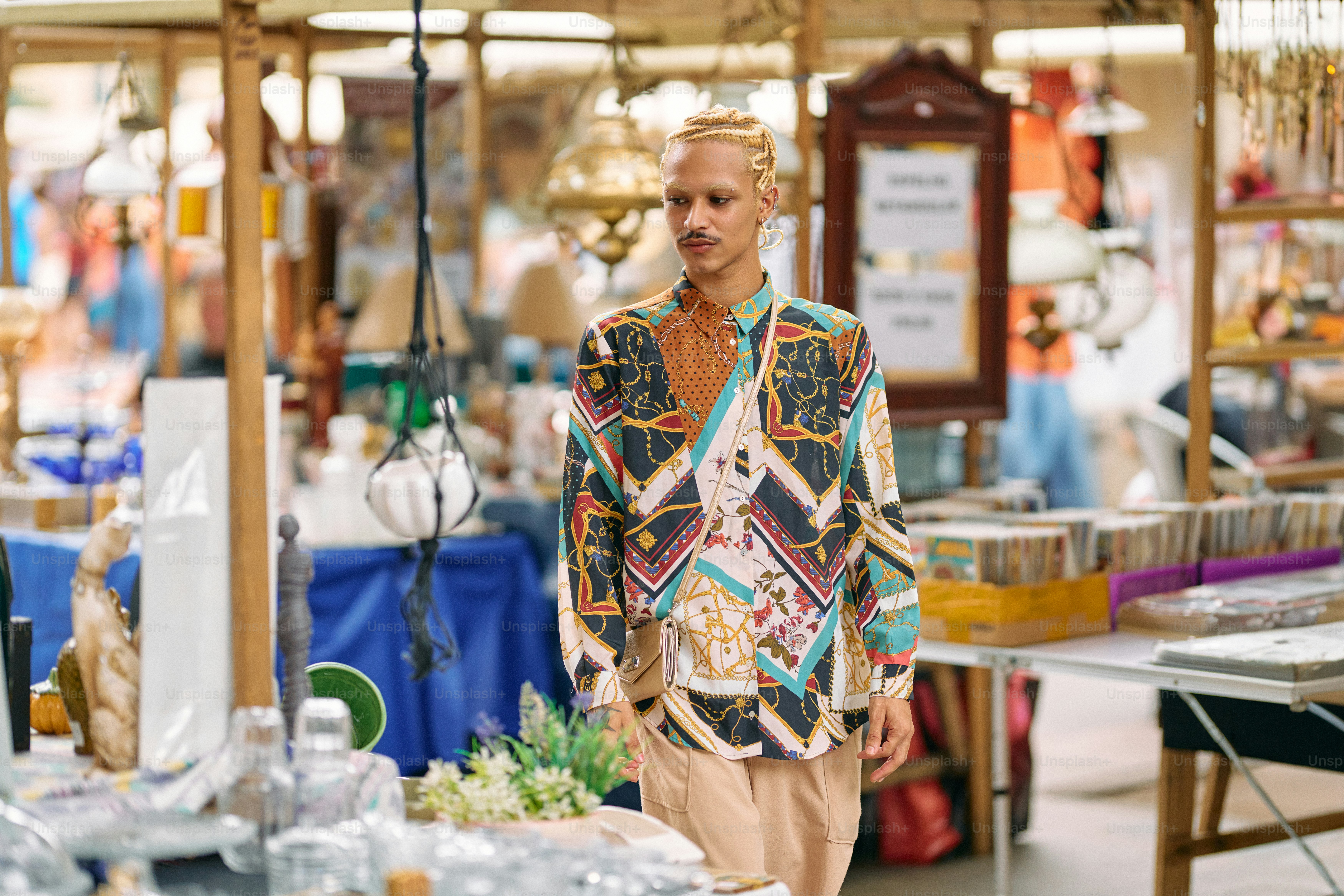A man walking through a store filled with lots of items