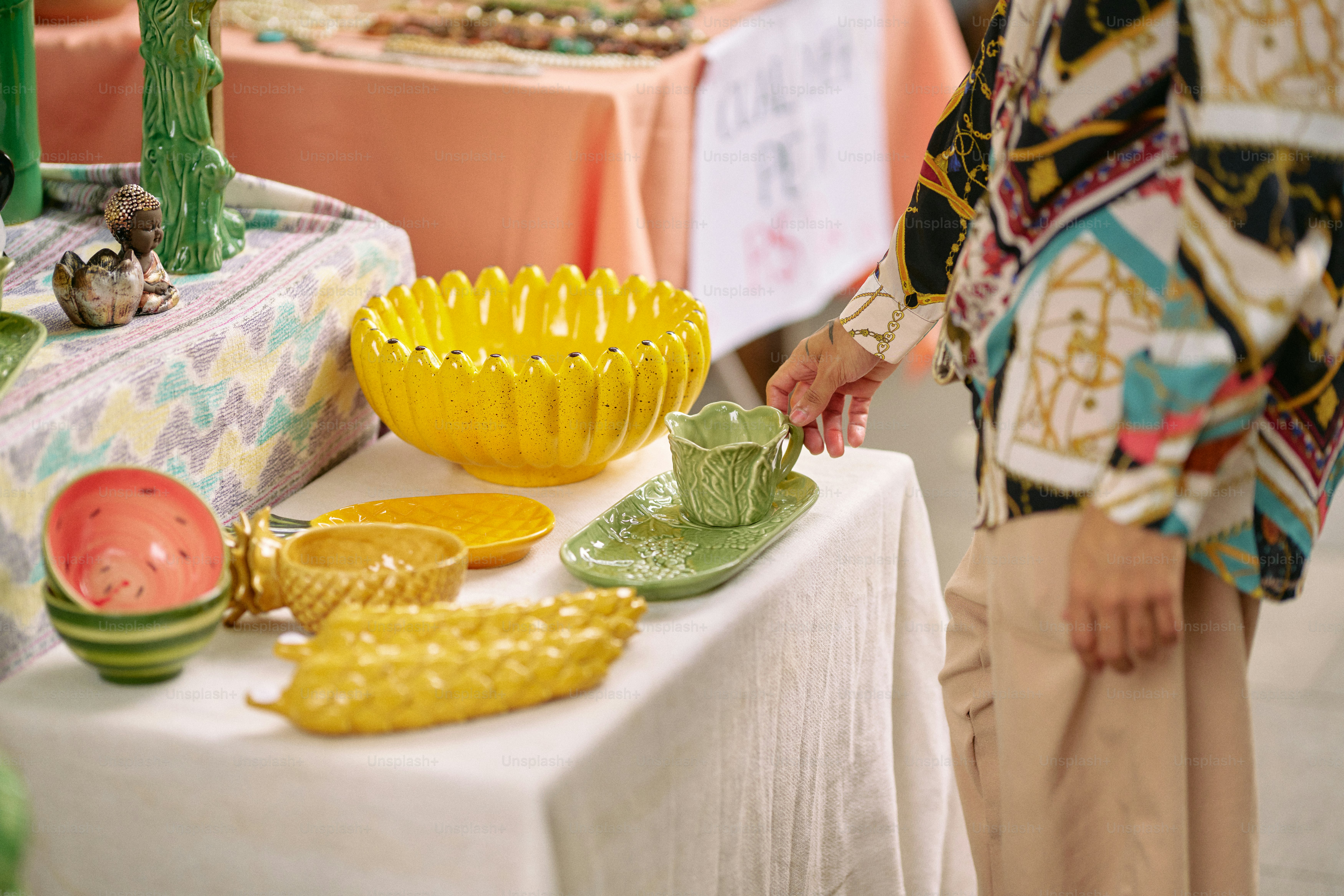 Eine Frau, die neben einem Tisch steht, der mit Tellern und Schüsseln gefüllt ist