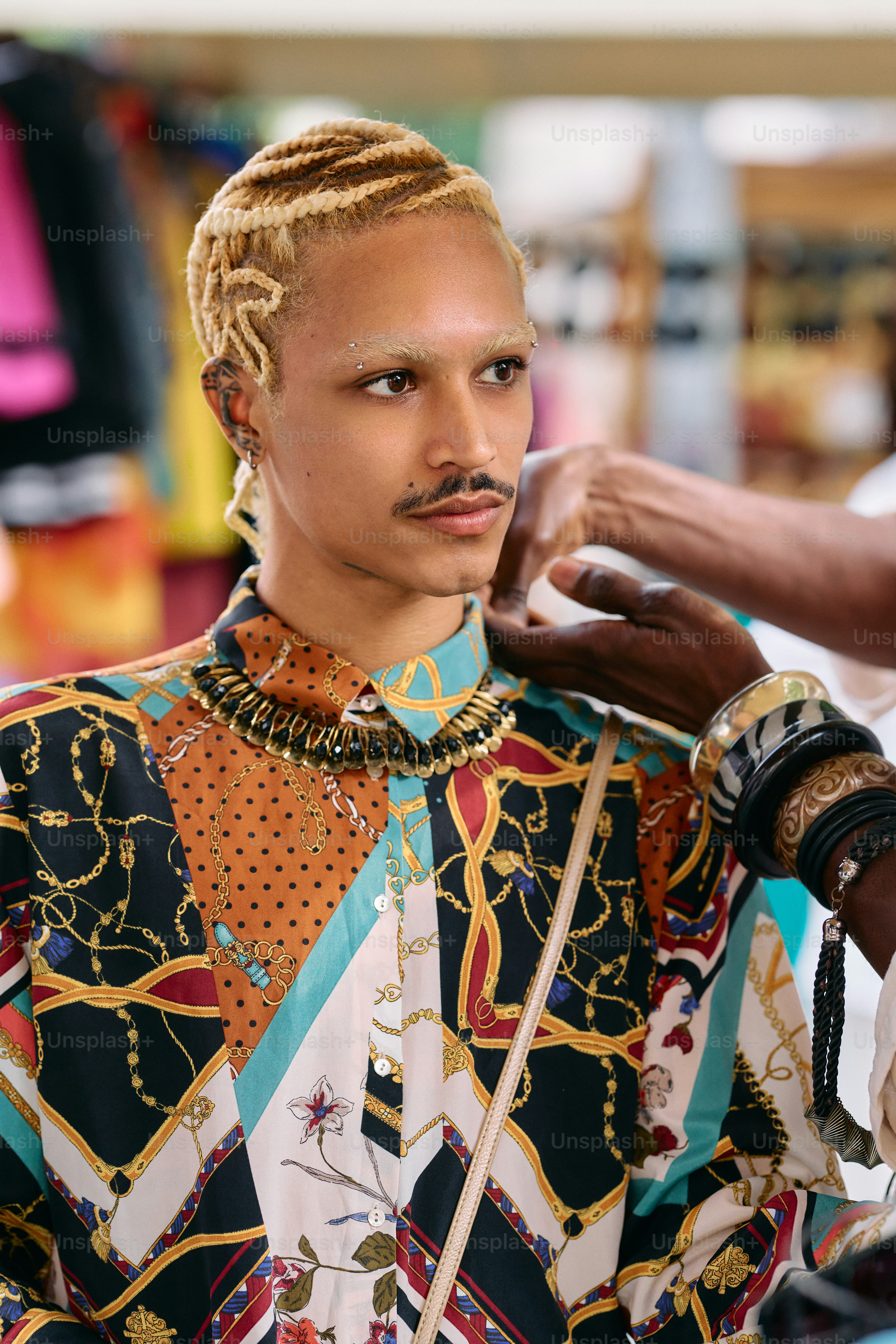 A man getting his hair styled by a woman