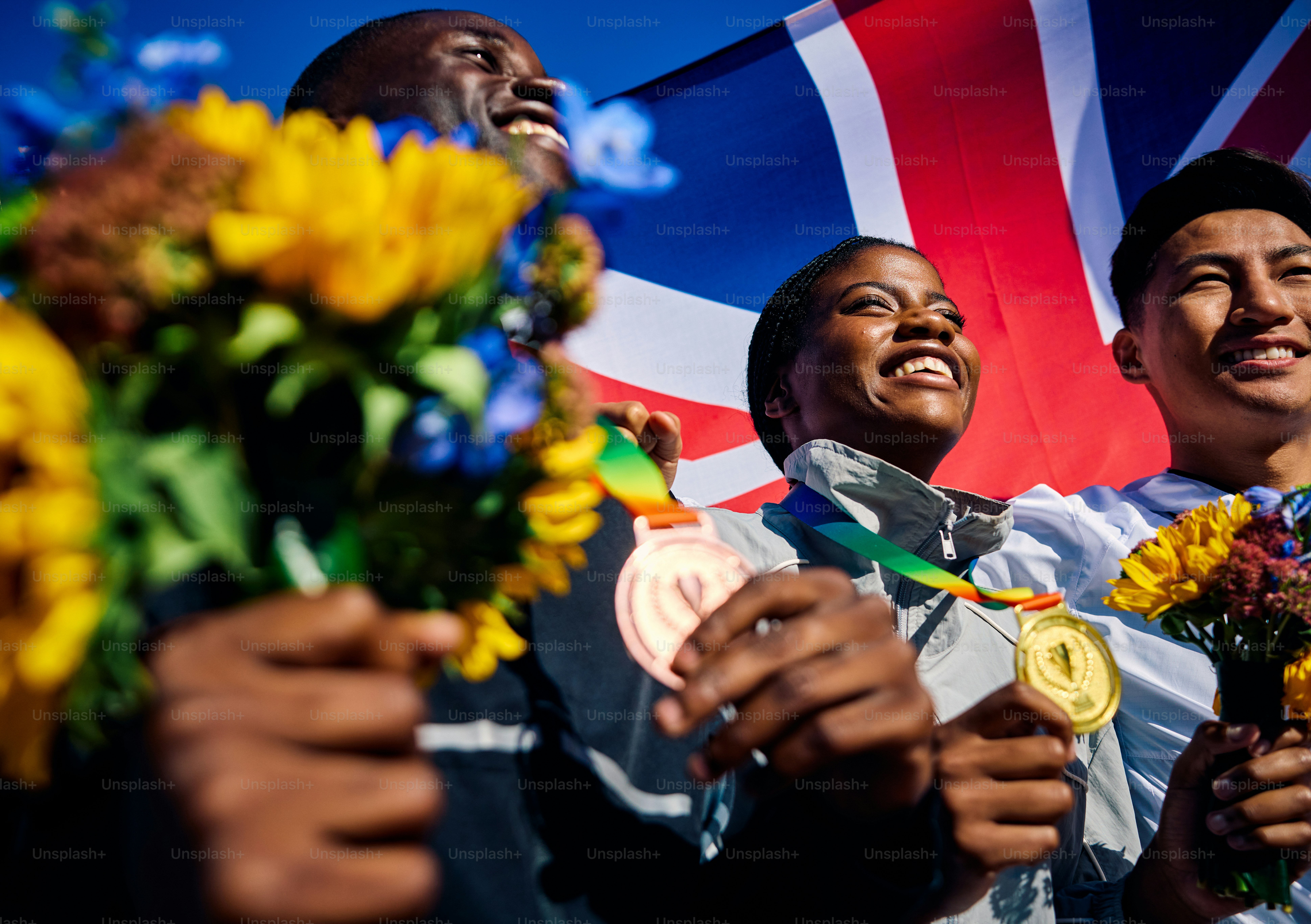 Ecstatic Team USA athletes with medals and bouquets against the ...