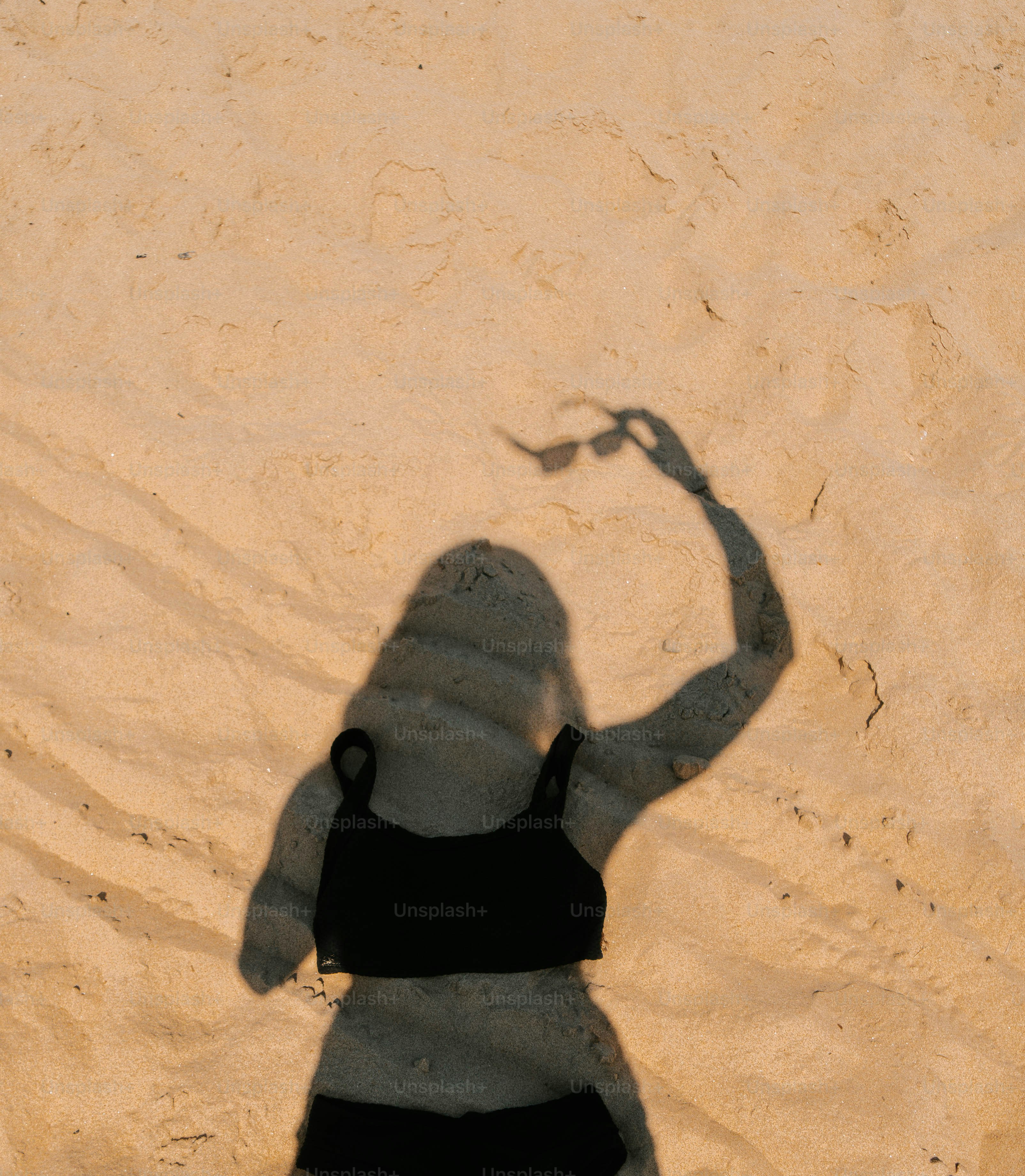 A shadow of a woman holding a tennis racquet