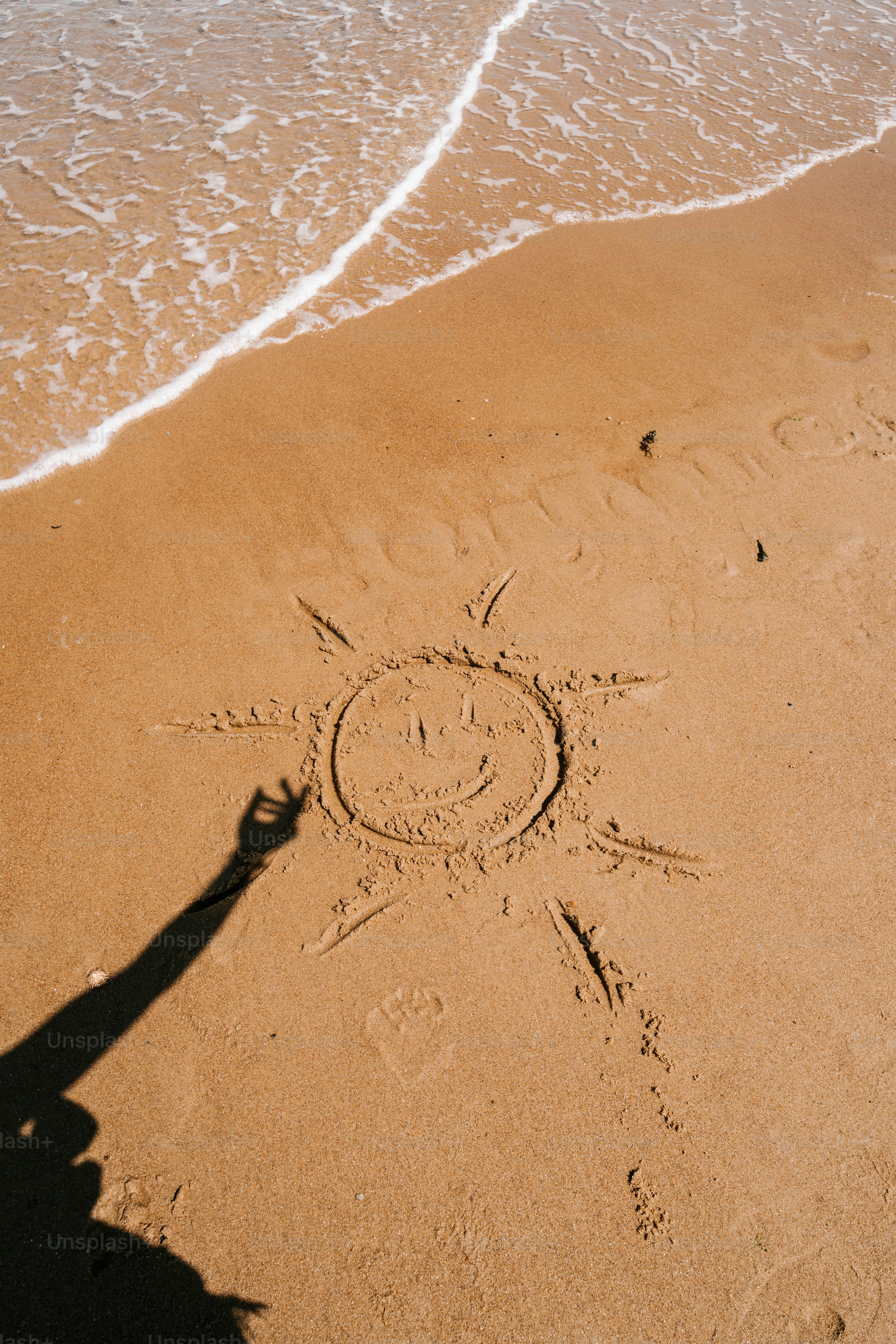 A person standing on a beach next to the ocean