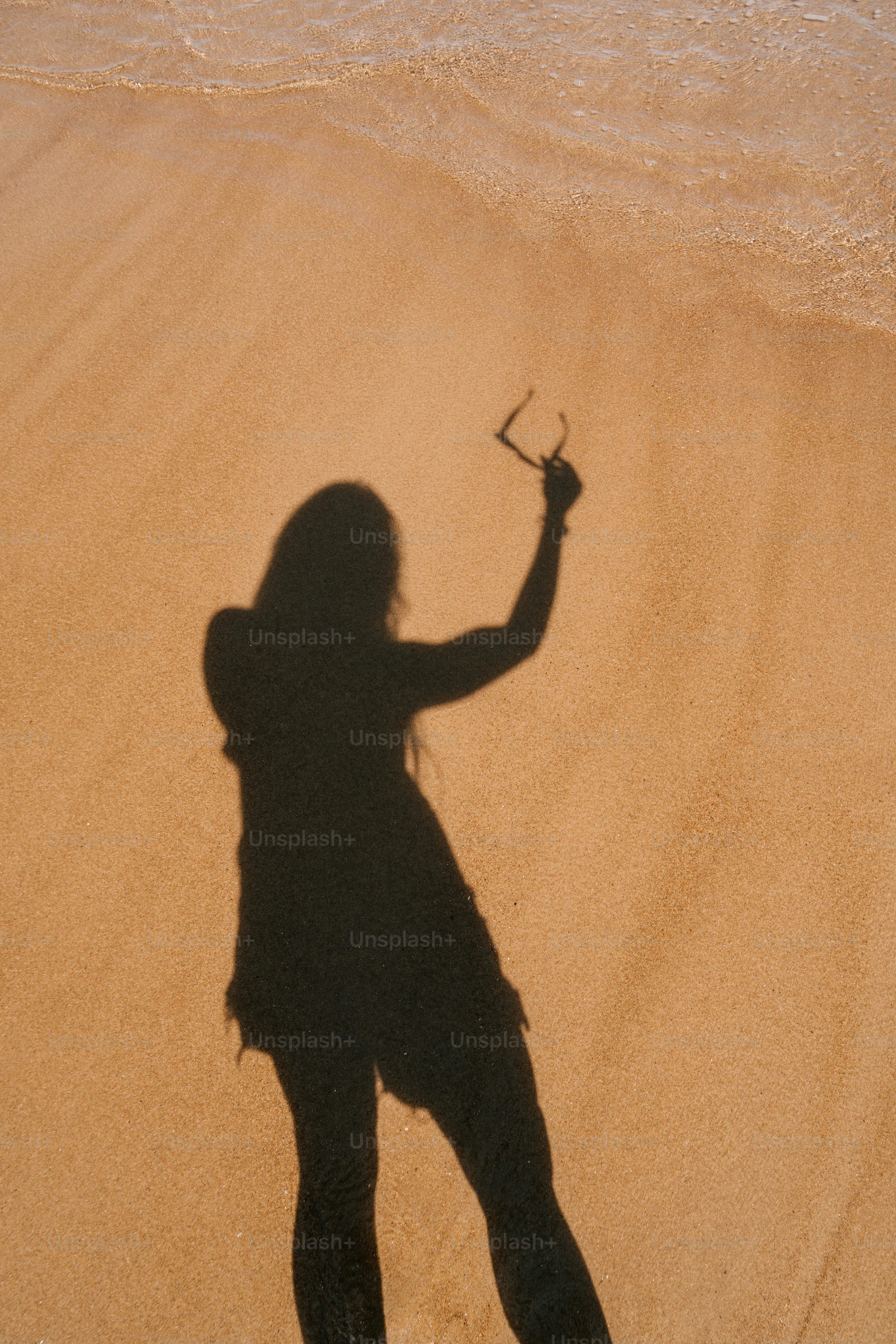 A shadow of a woman on the beach