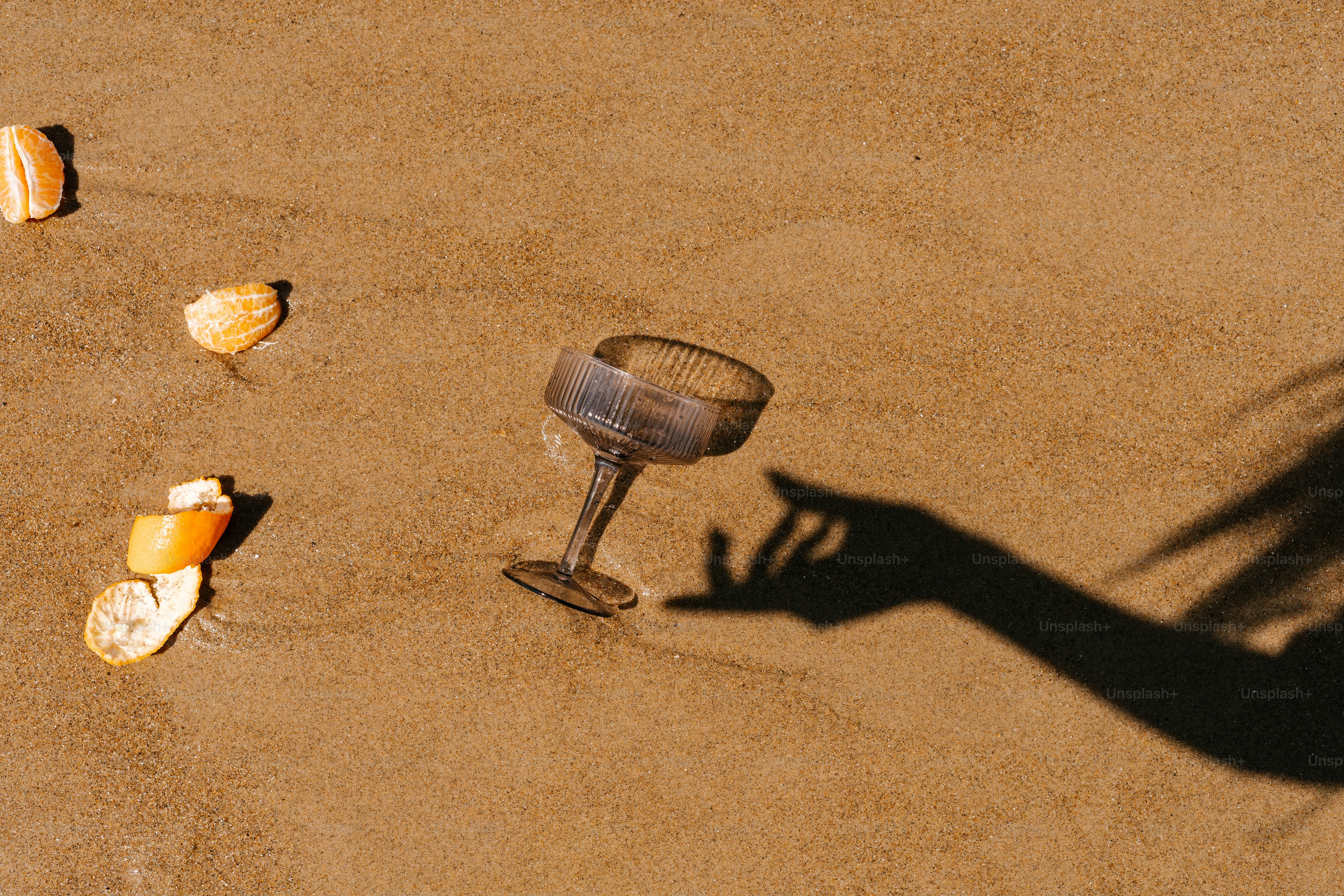 A shadow of a person holding a wine glass