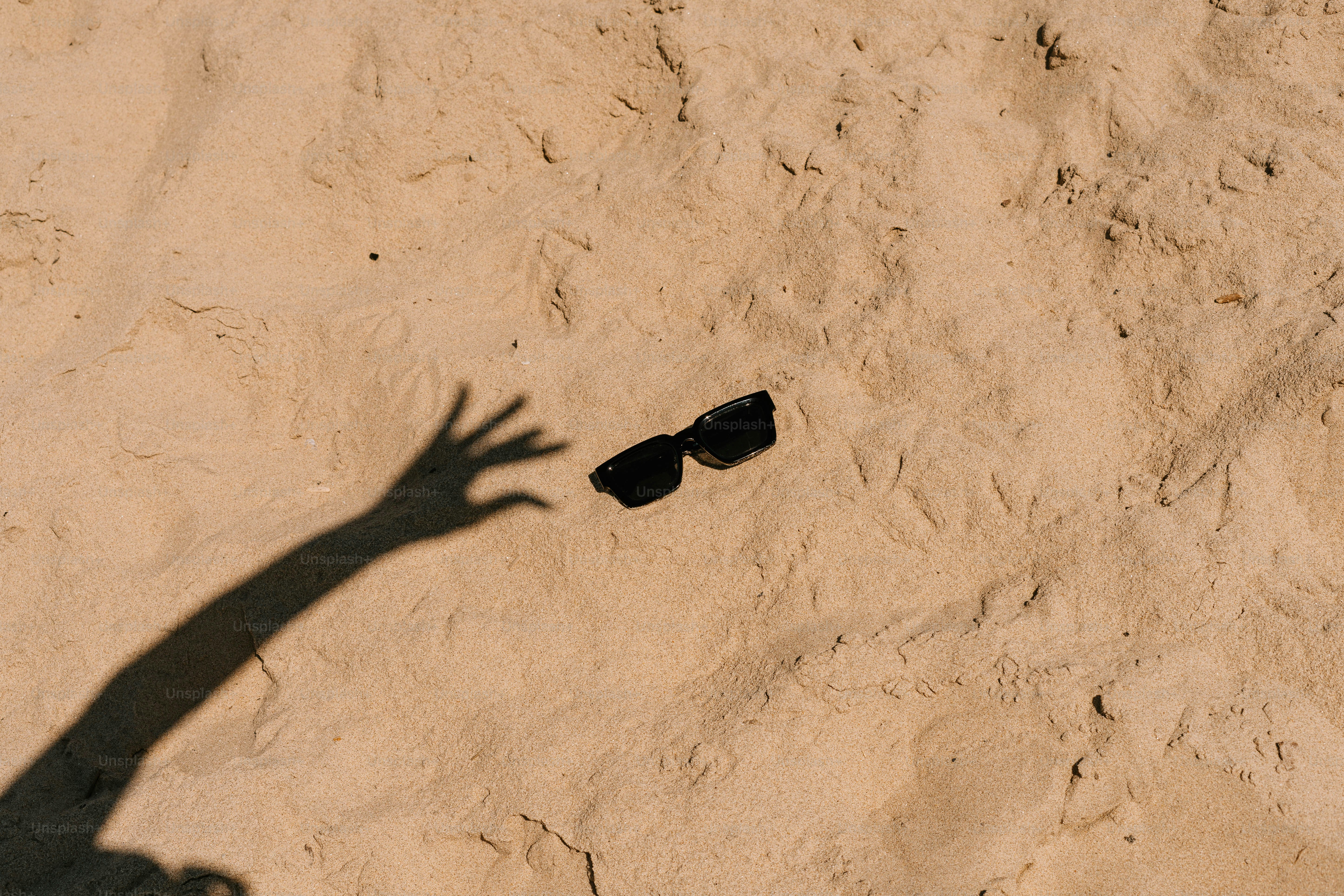 A shadow of a person throwing a frisbee
