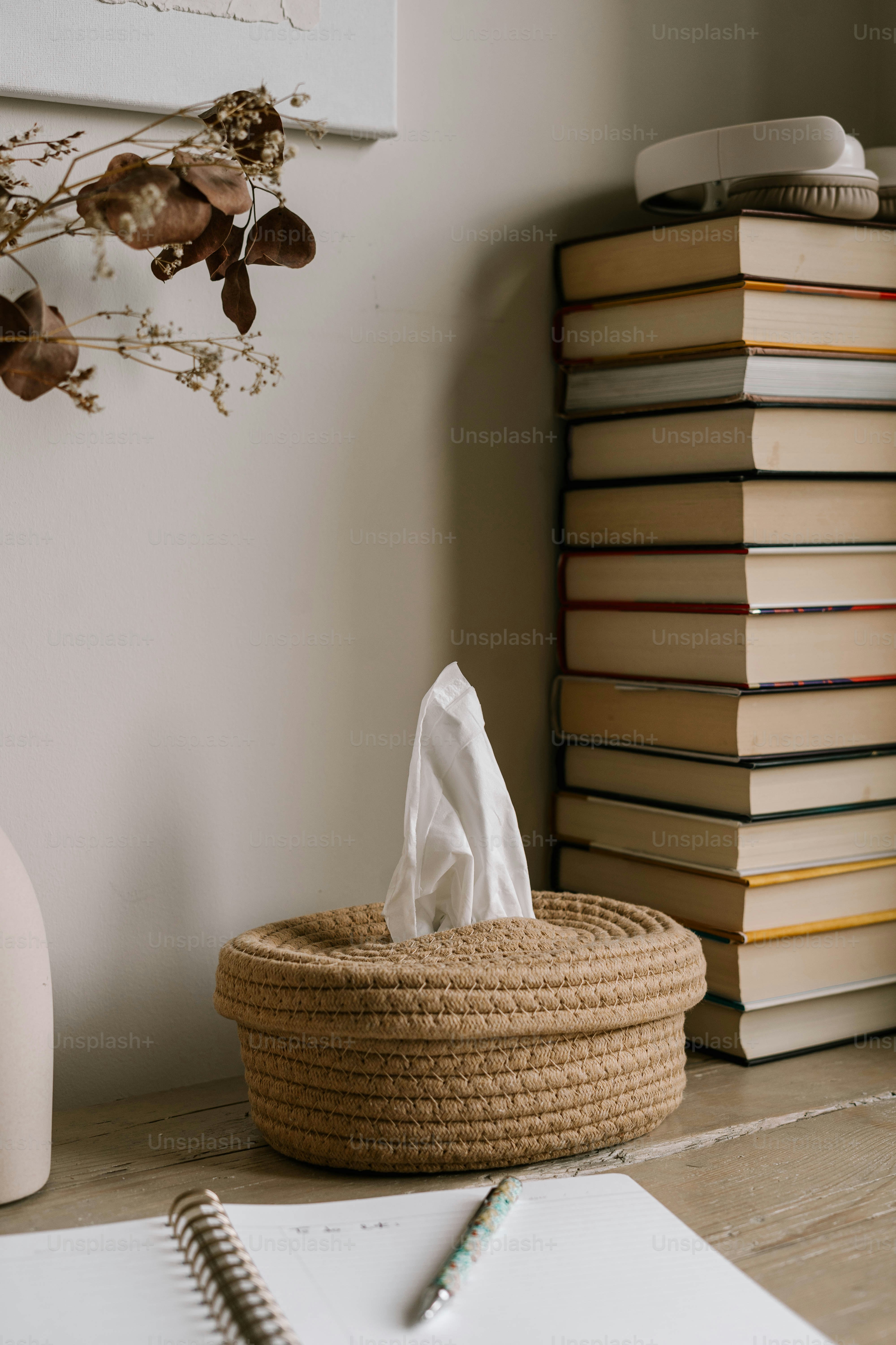 Une pile de livres posée à côté d’un panier