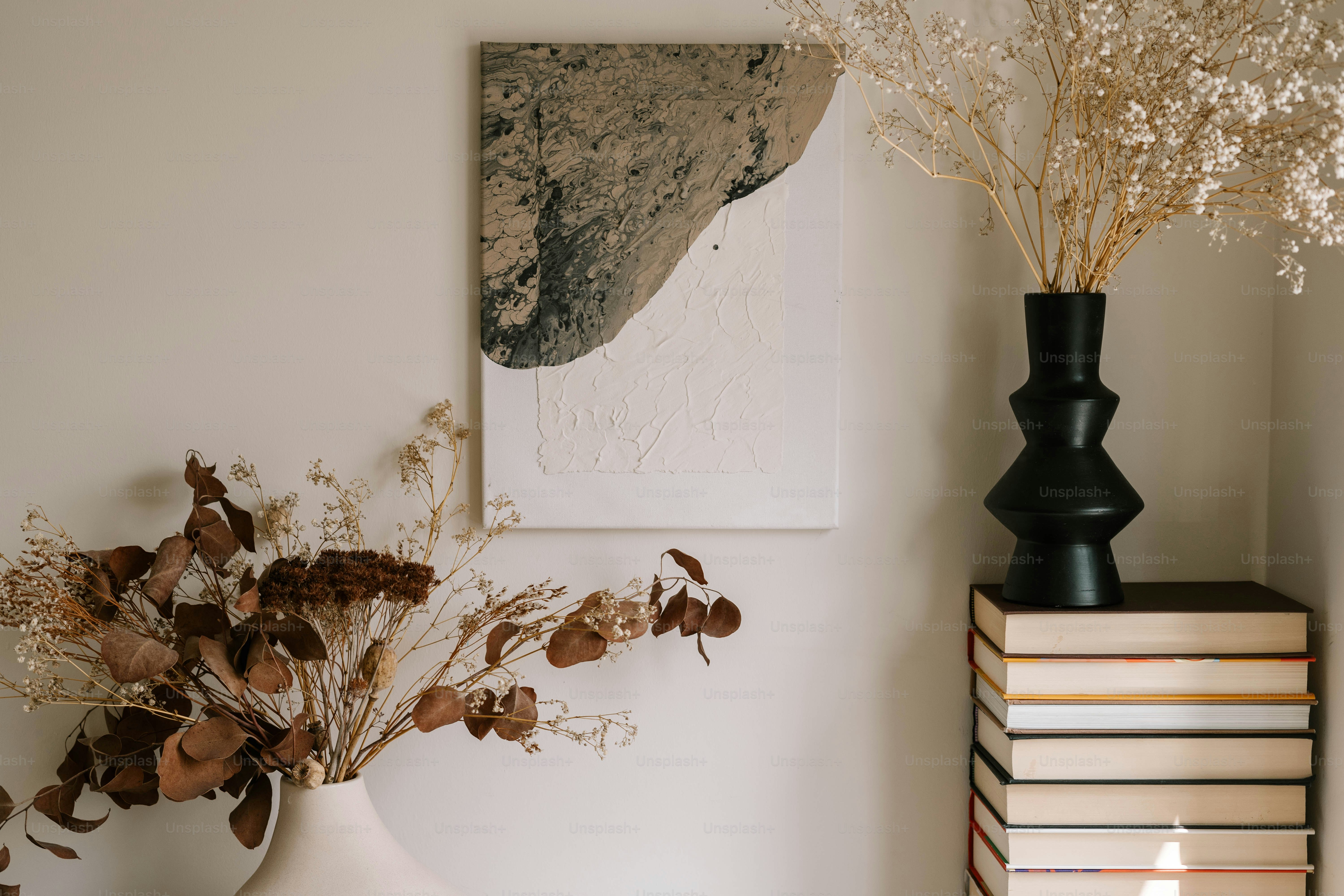 A vase with flowers and a candle on a table