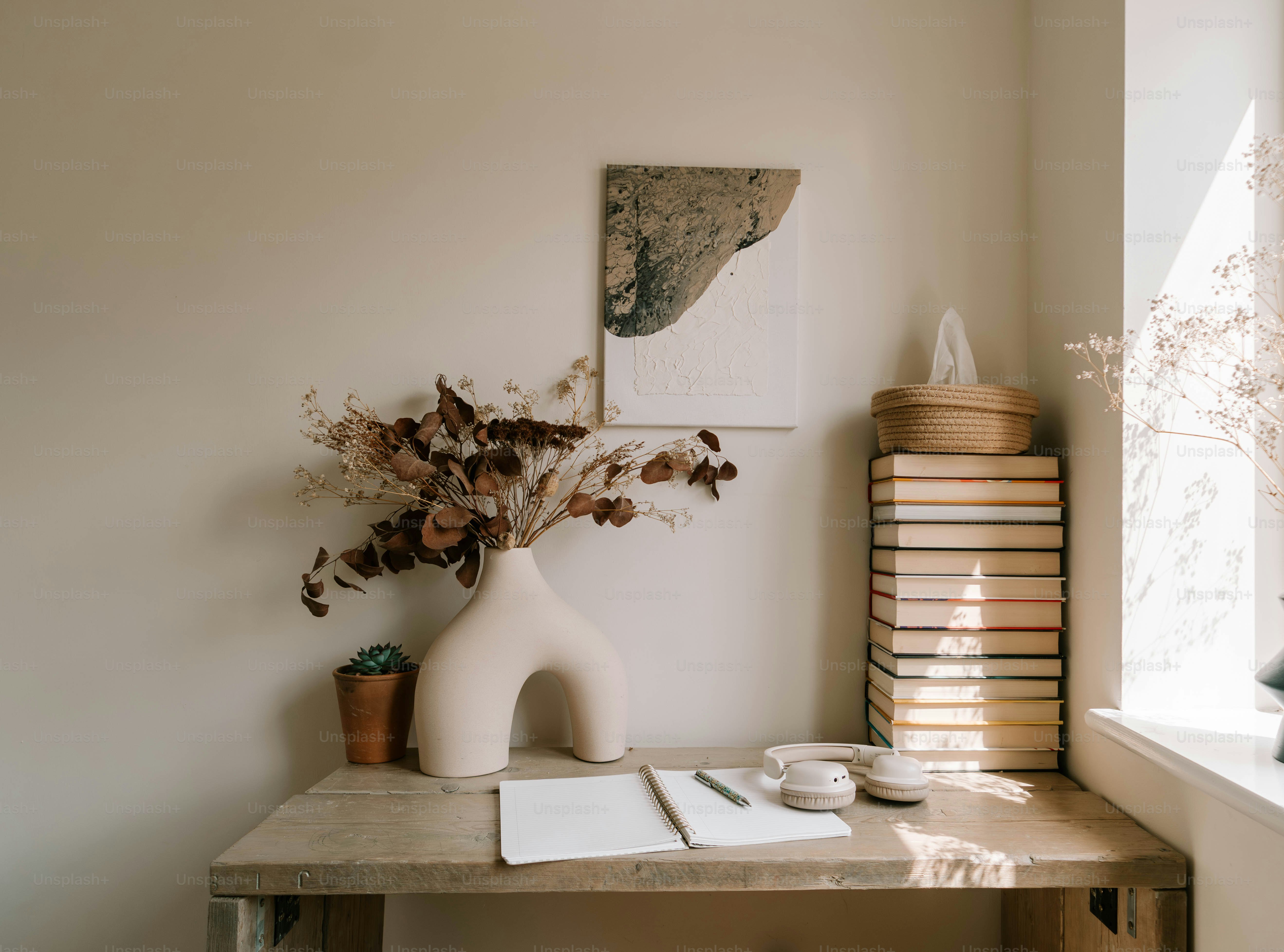 A desk with a vase of flowers on it