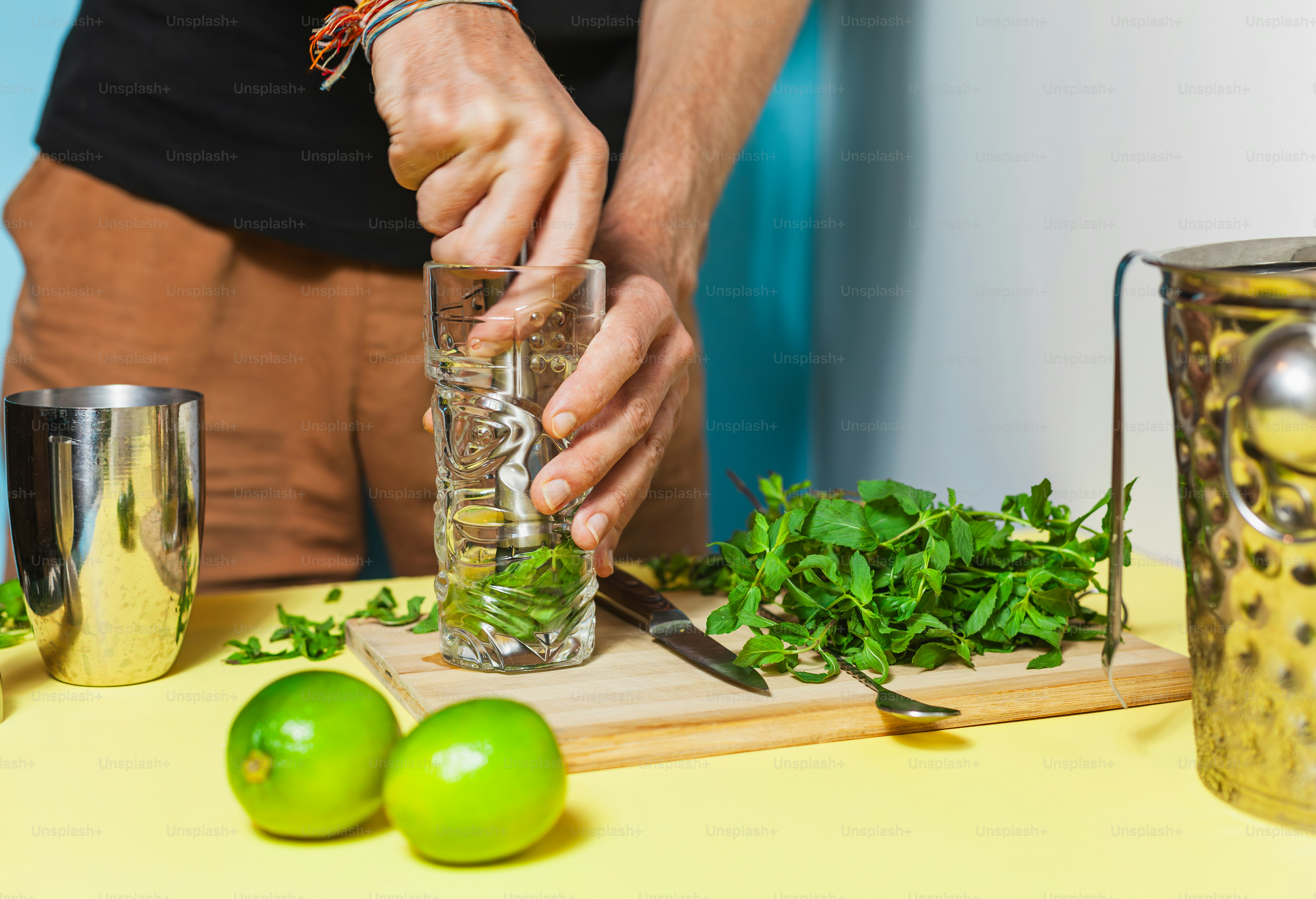 A man is preparing a drink on a table
