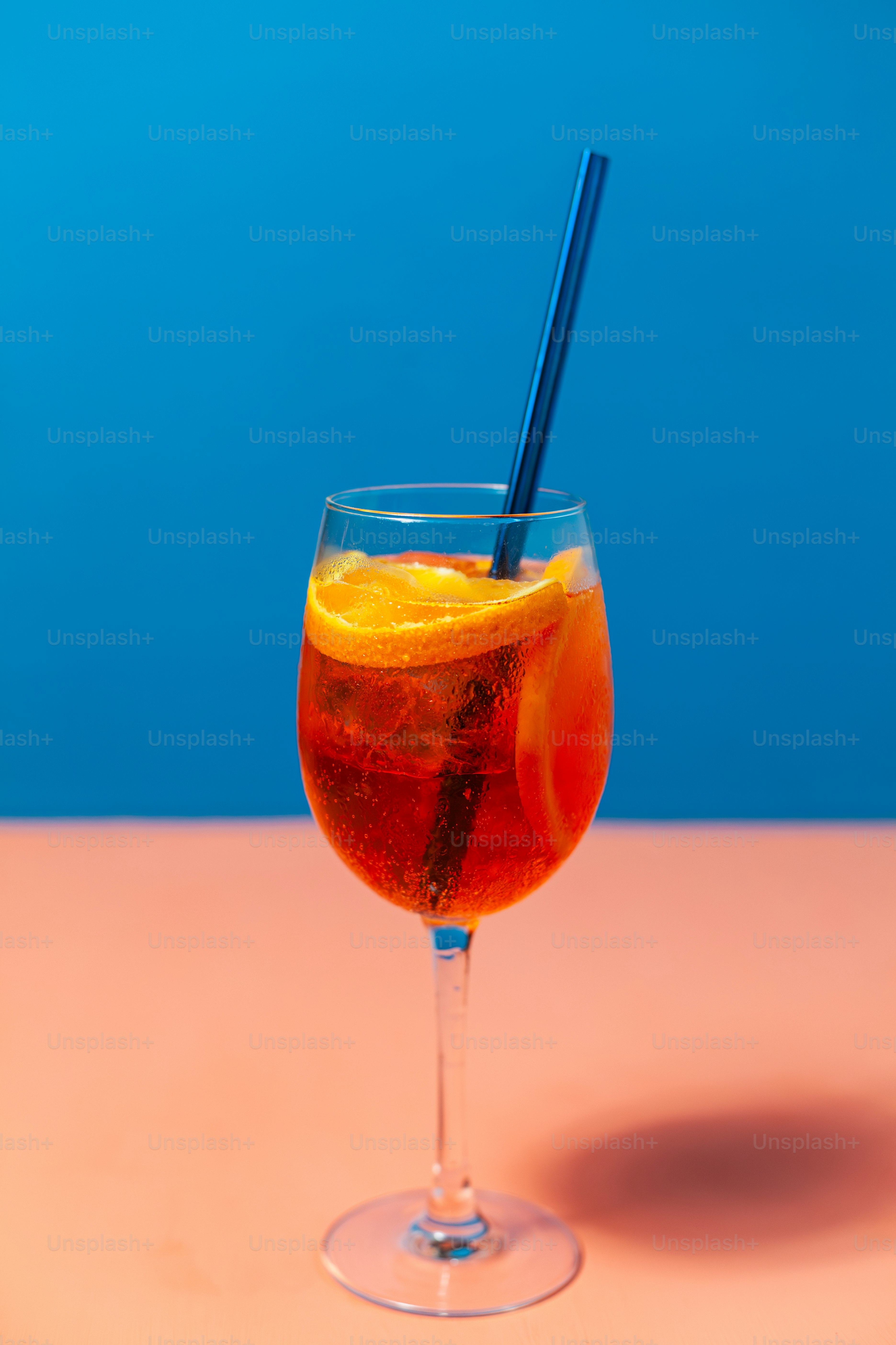 A glass with a drink and a straw in it