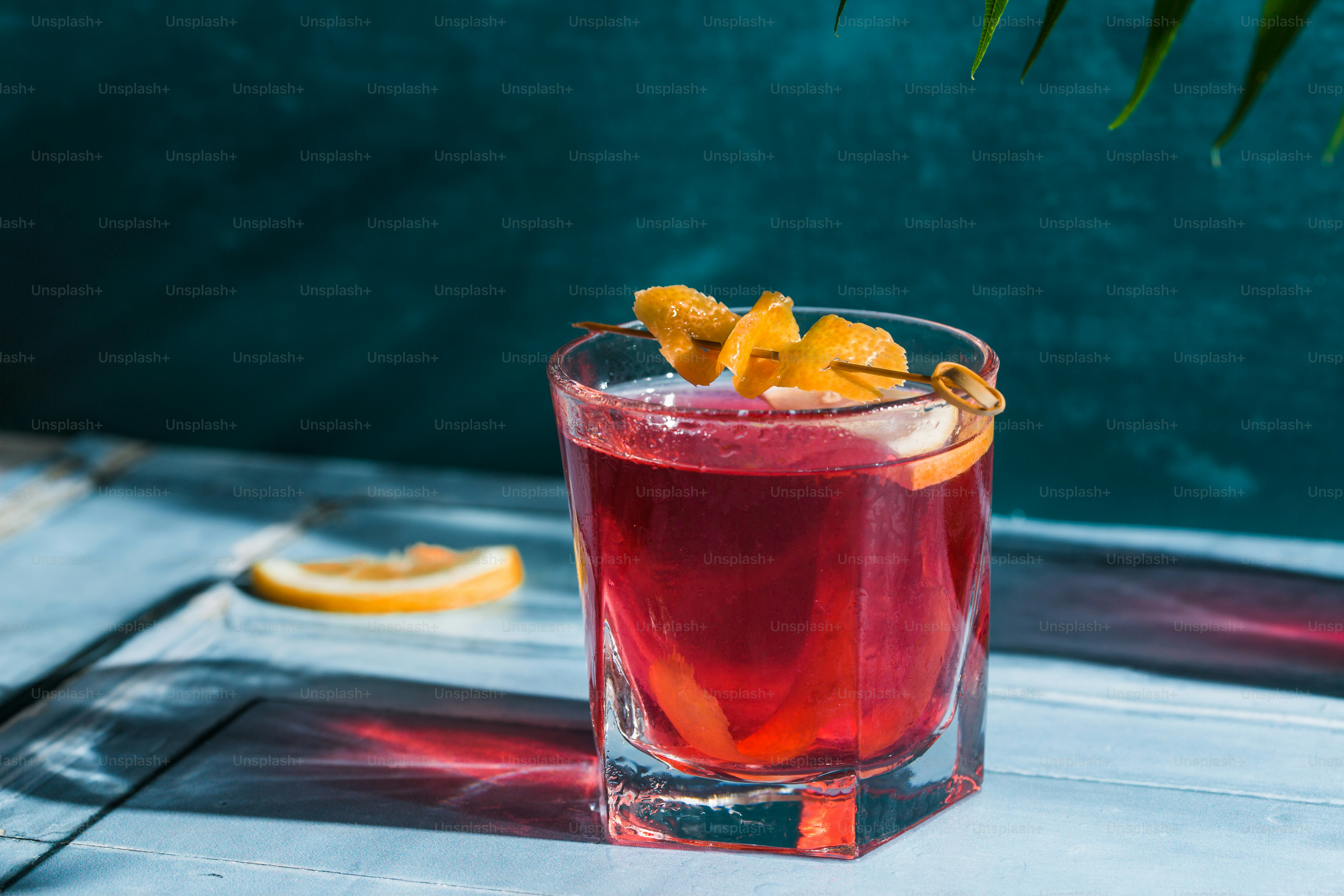 A glass filled with a drink sitting on top of a table