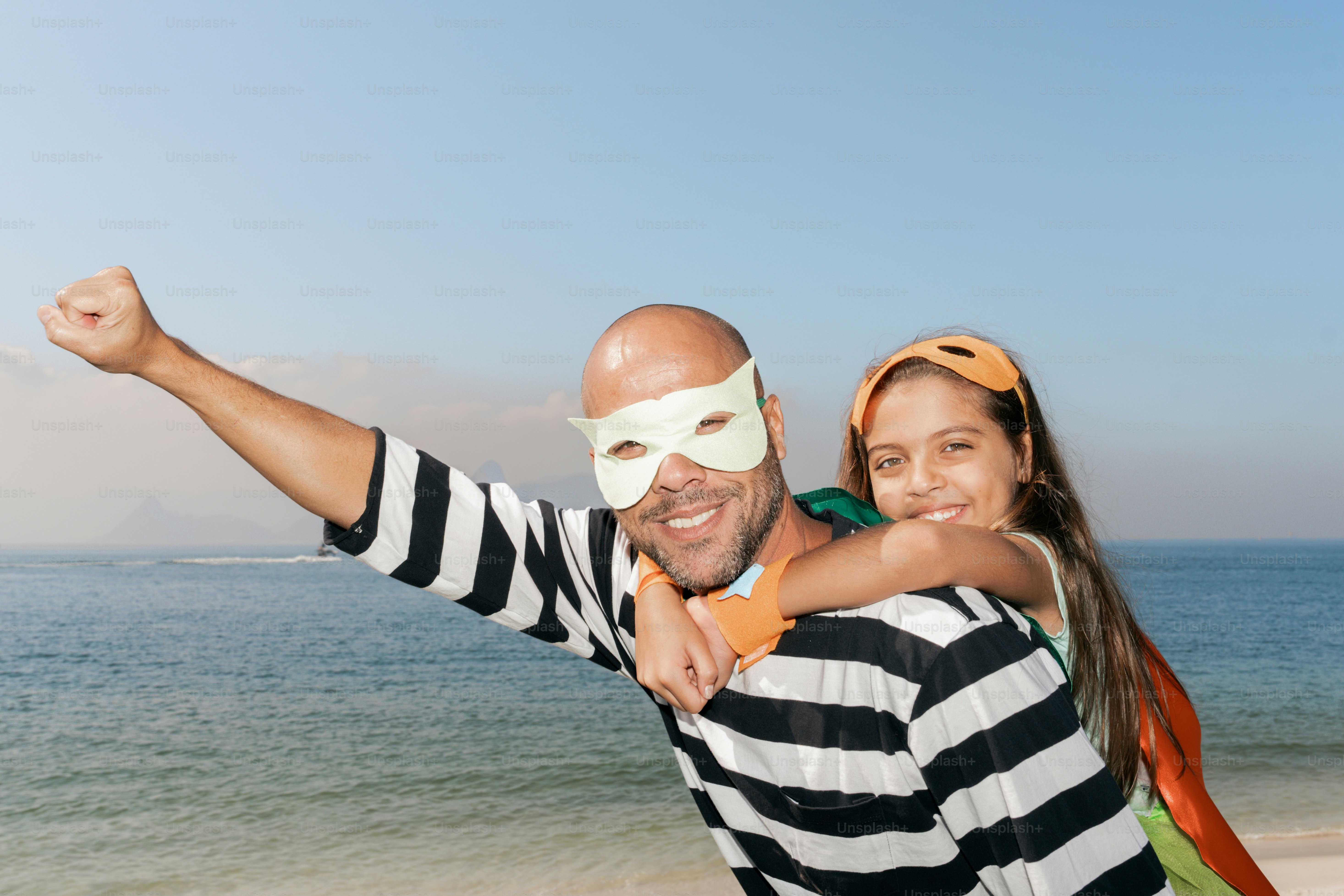 A man holding a woman on the beach