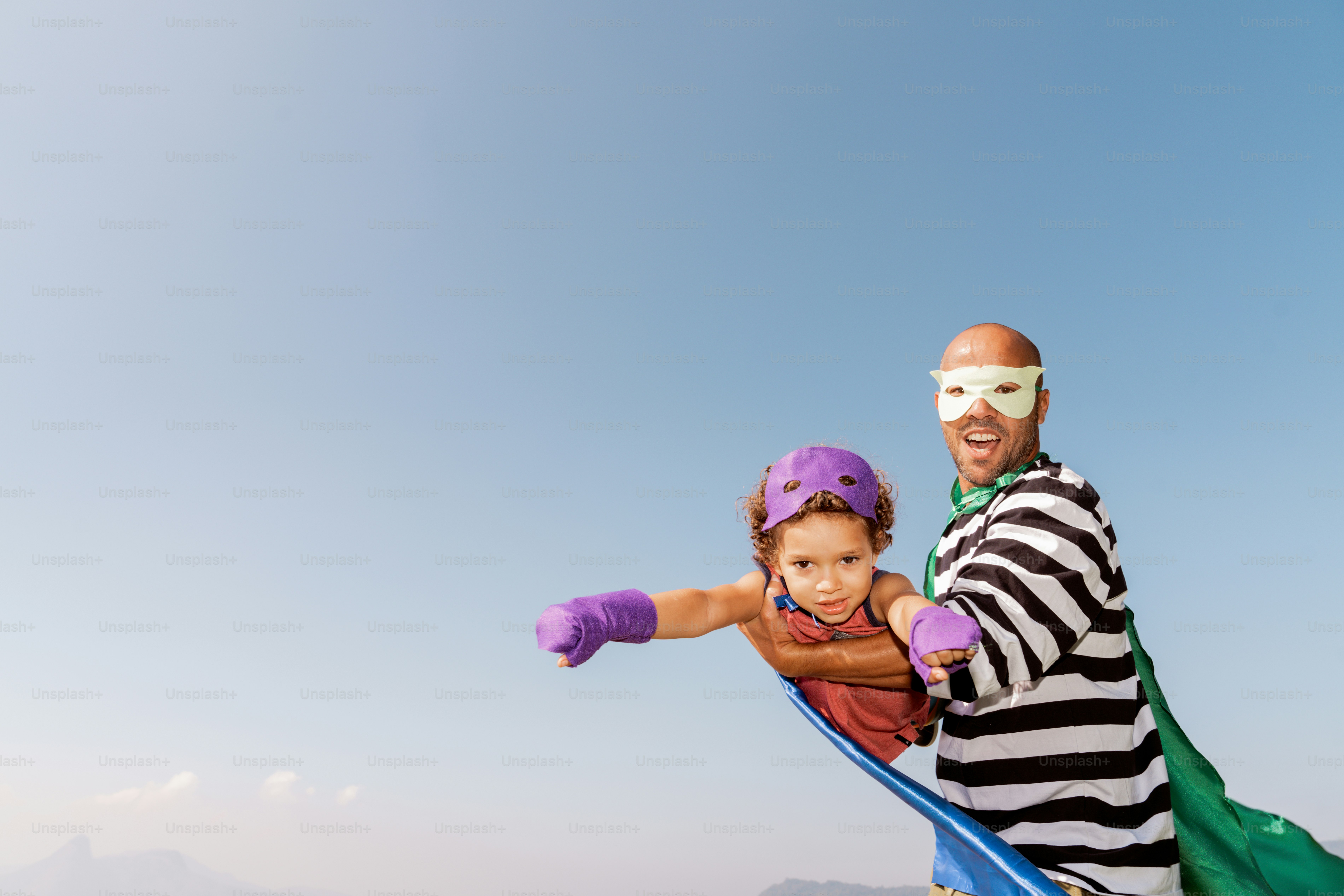 A man and a little girl on a snowboard