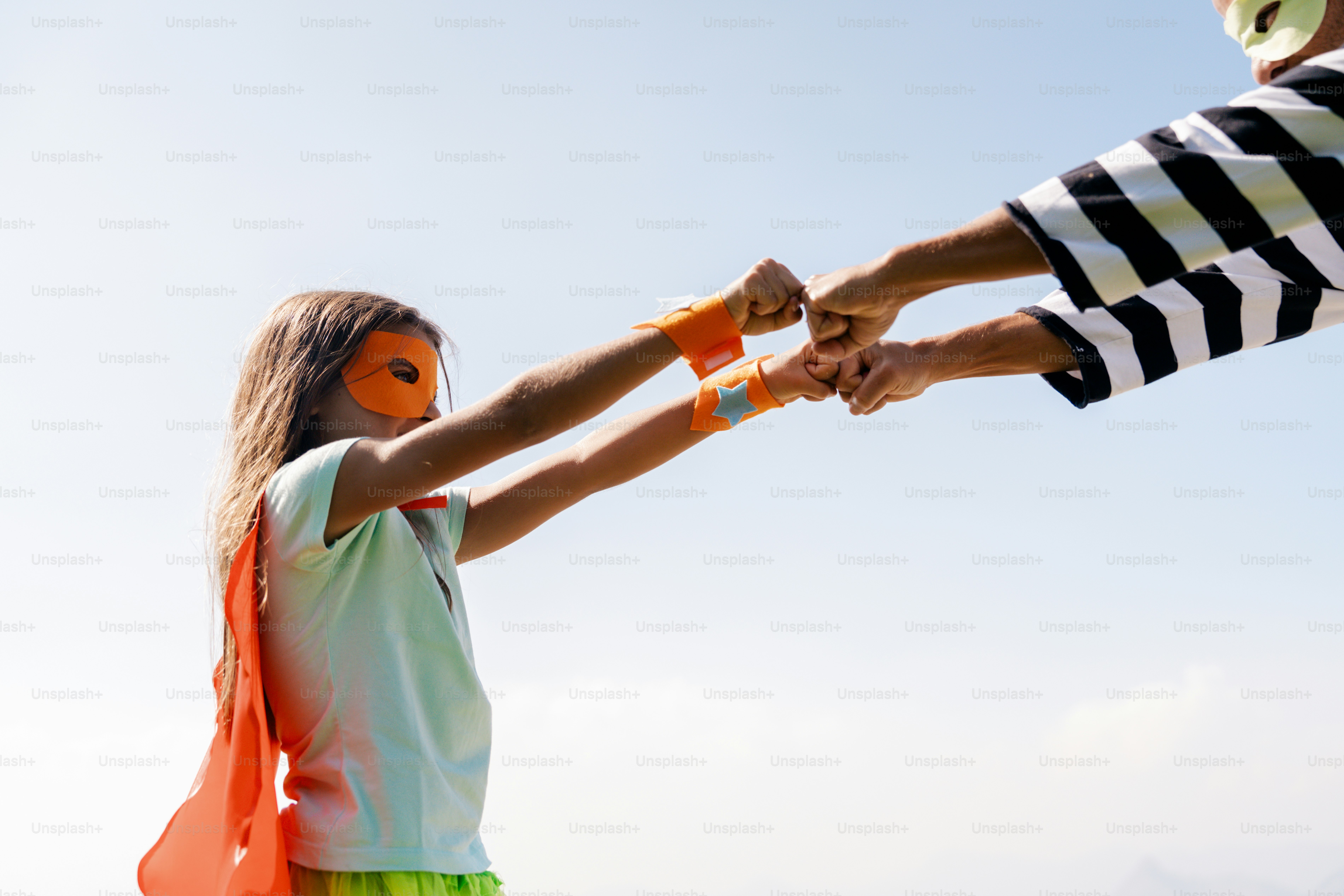 A couple of people that are flying a kite