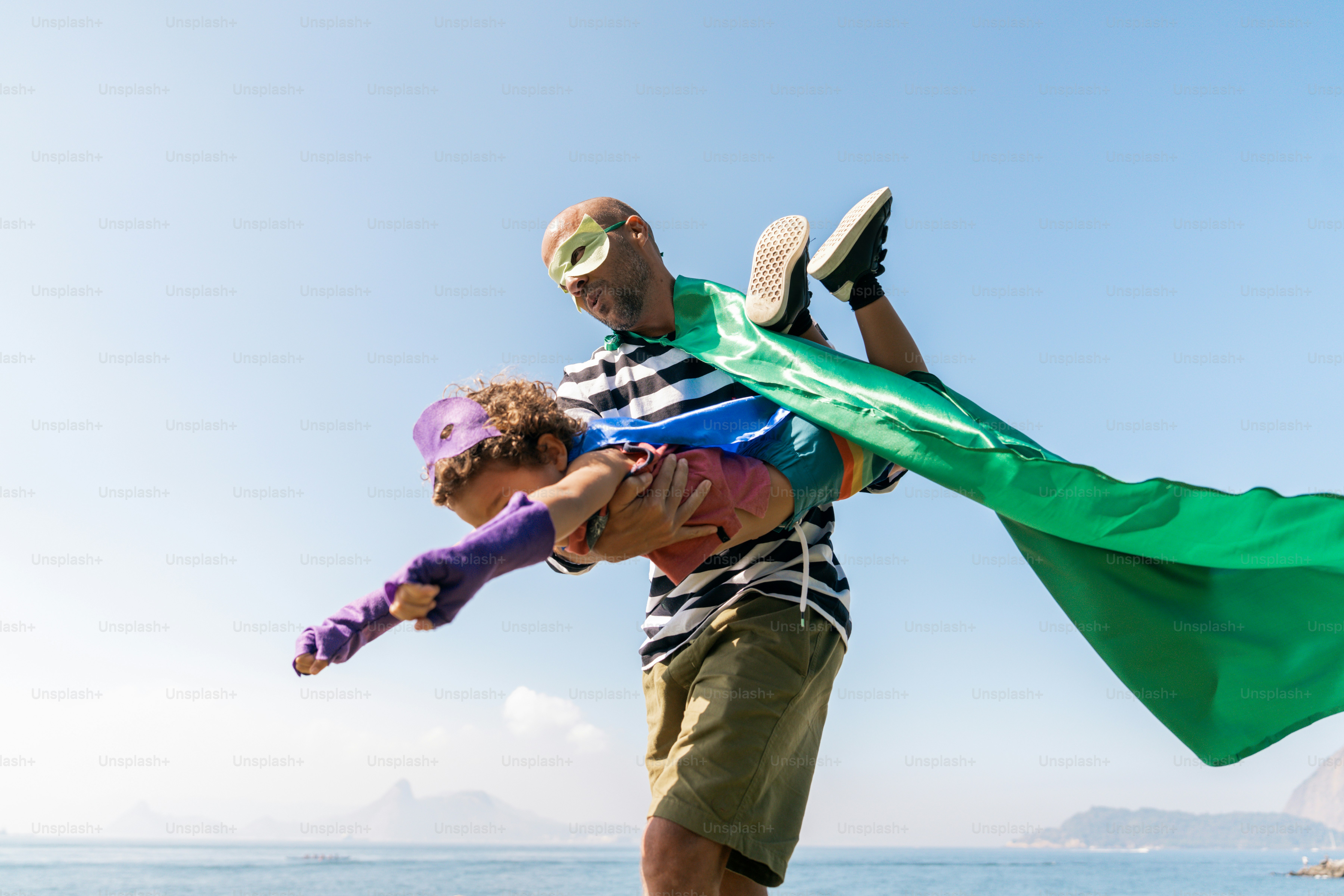A man is holding a child on his shoulders
