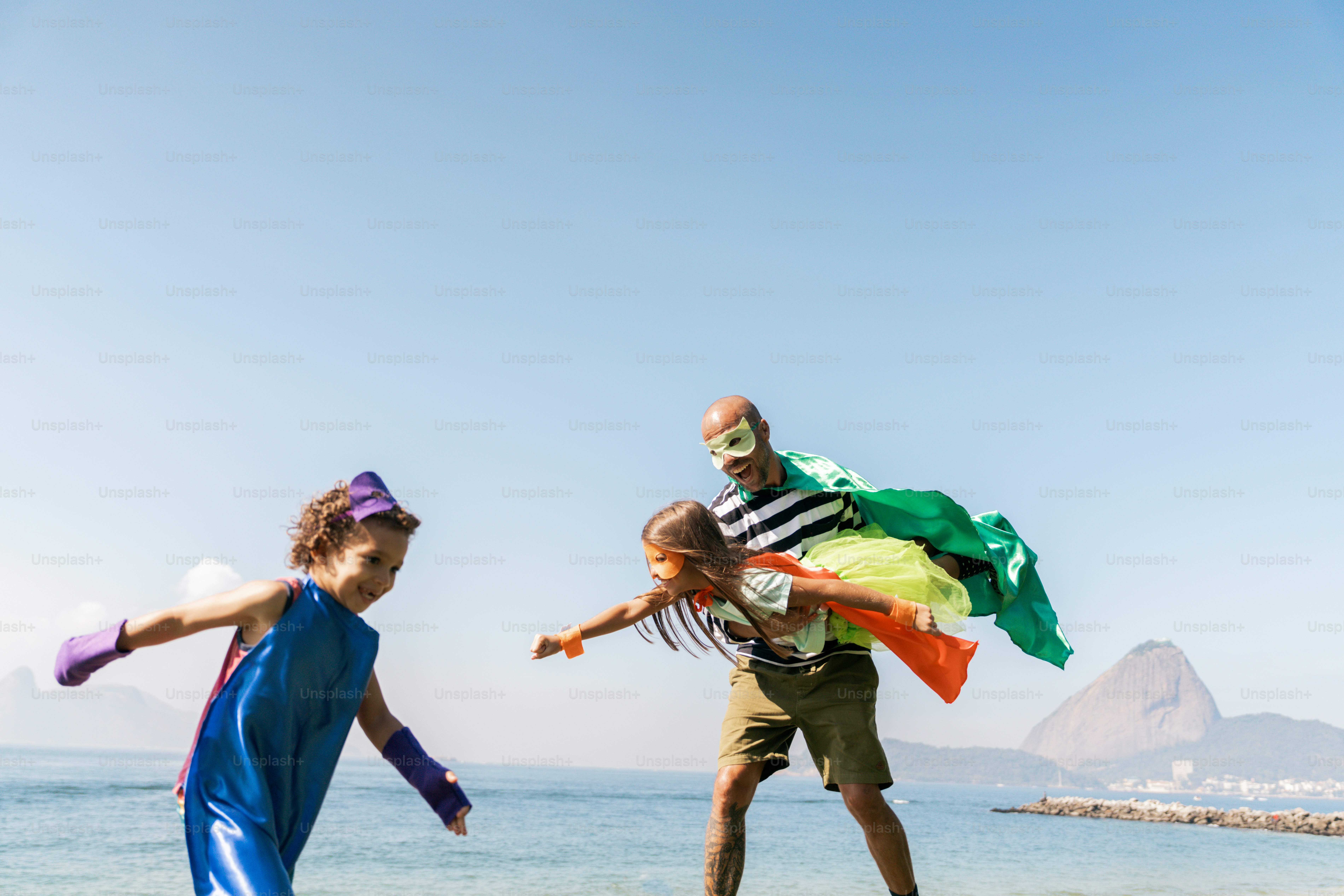 A couple of people that are standing in the sand