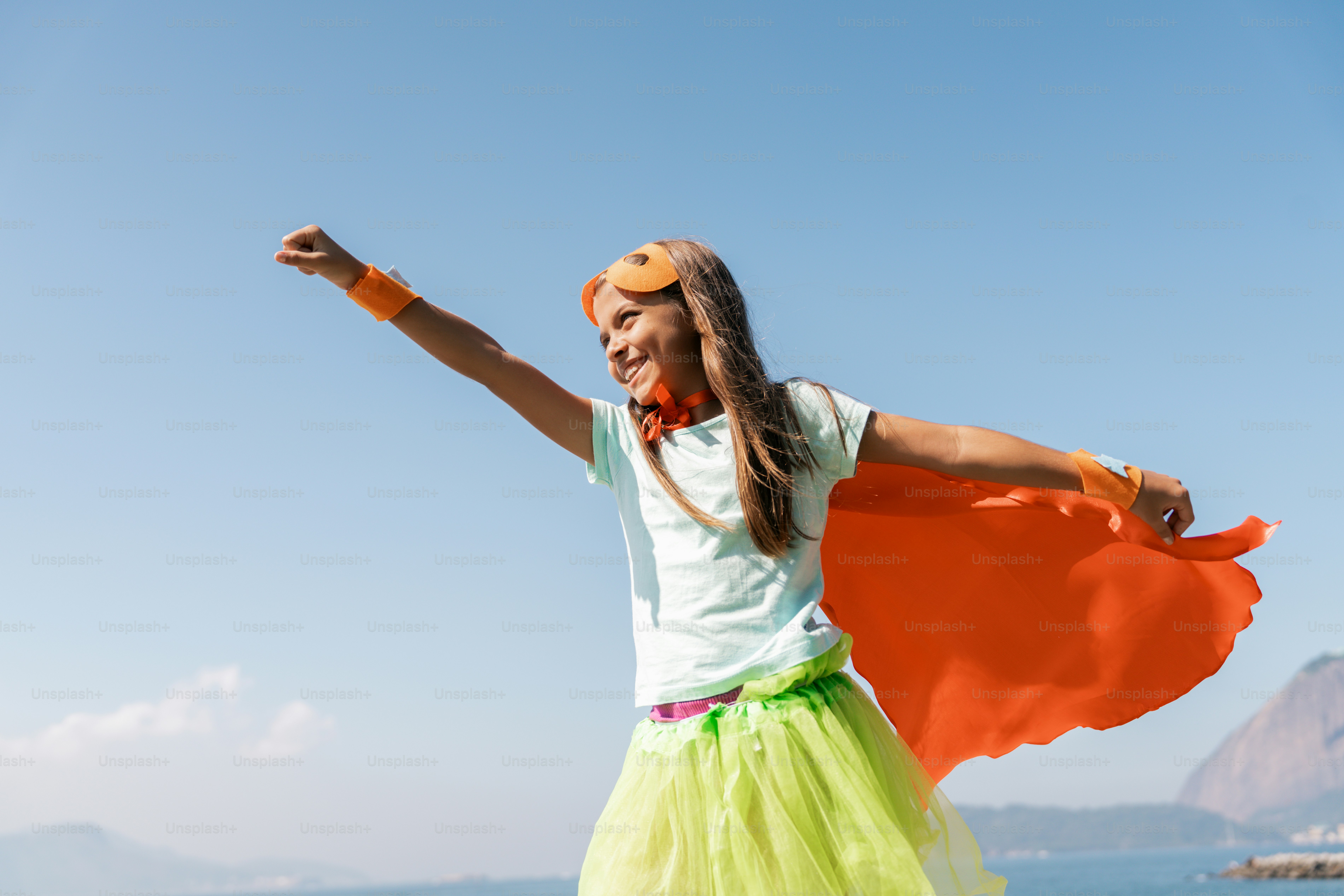 A girl in a green tutu and a white t - shirt