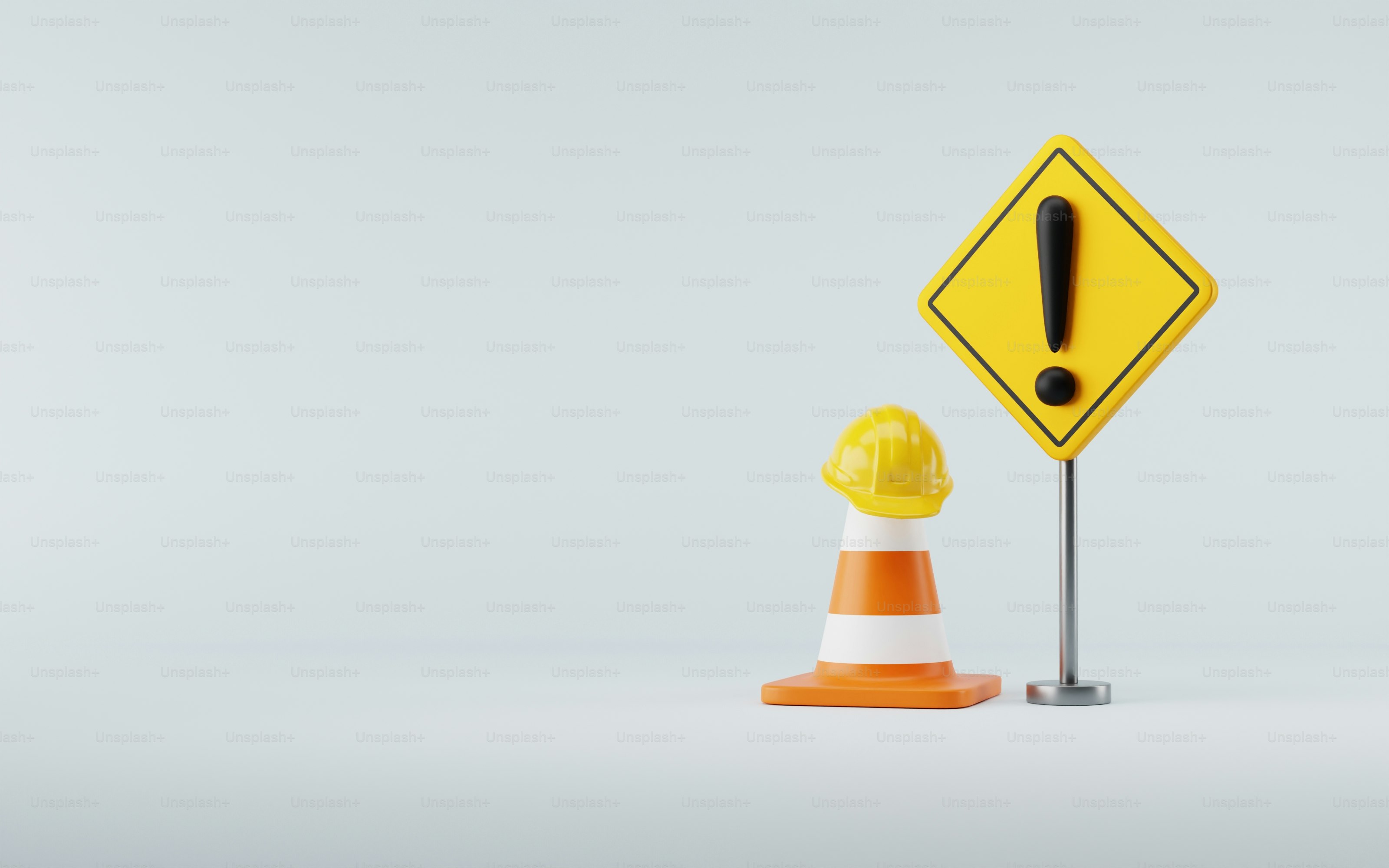 A yellow traffic sign next to a traffic cone