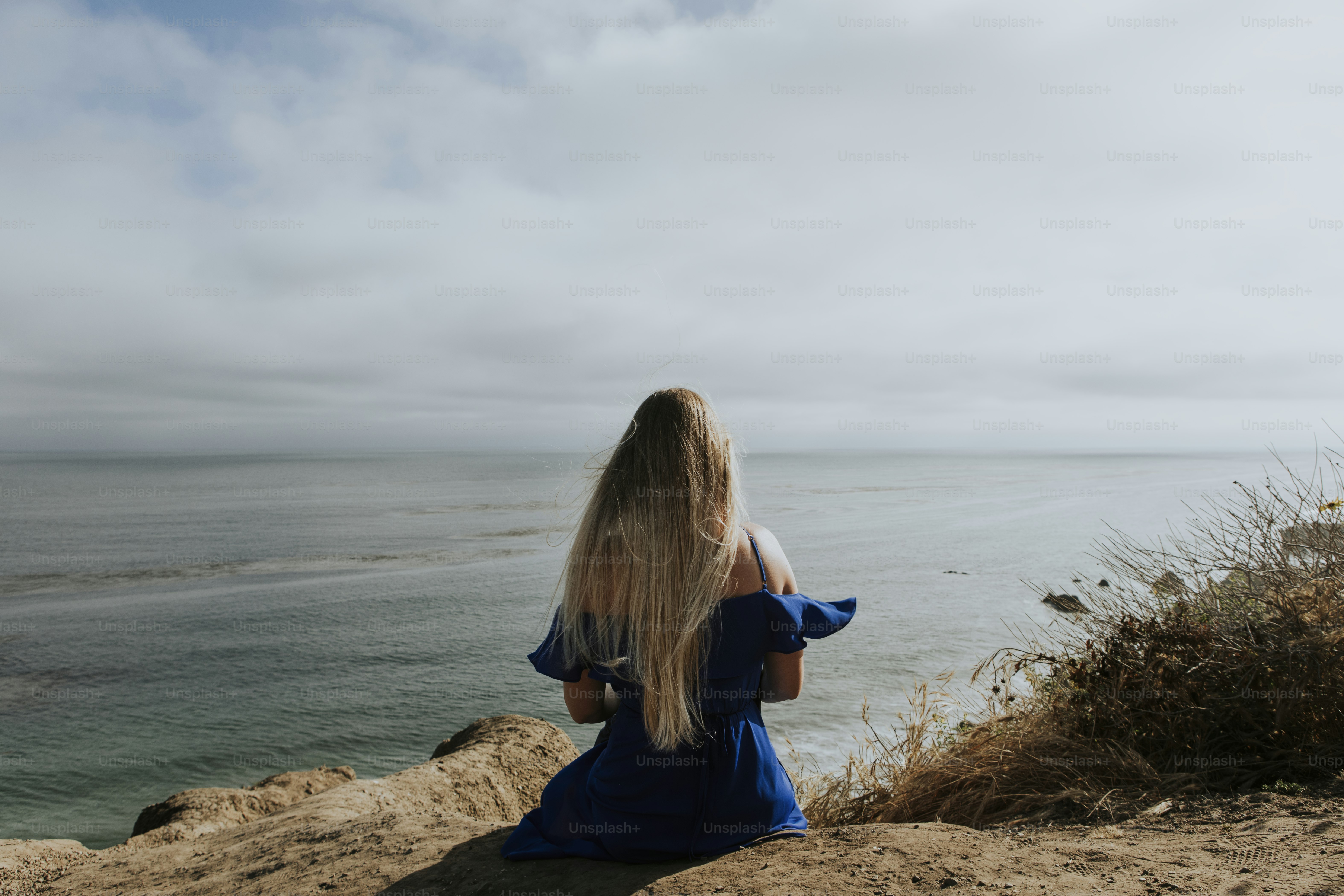 A woman sitting alone at the beach