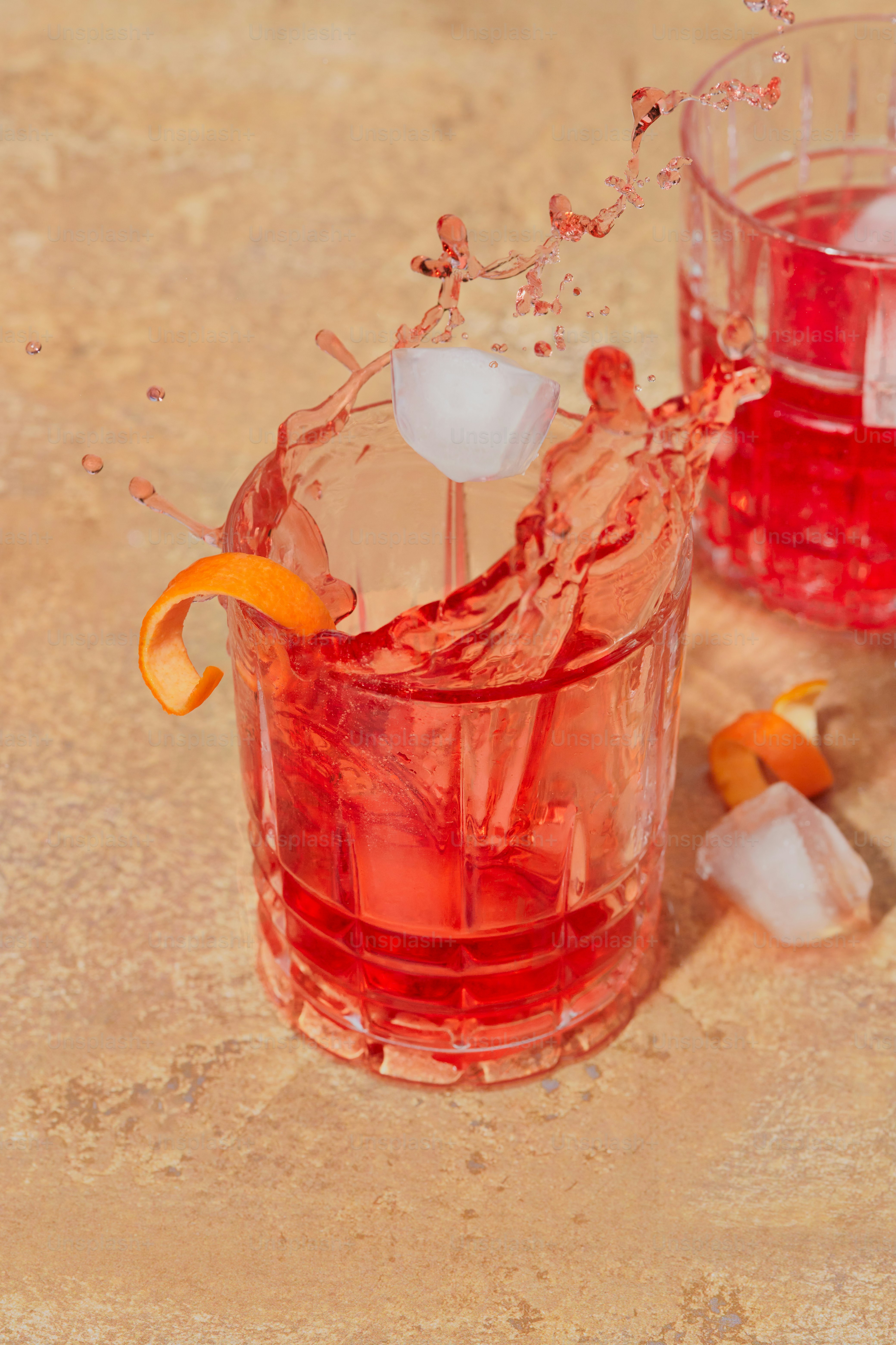 A couple of glasses filled with red liquid