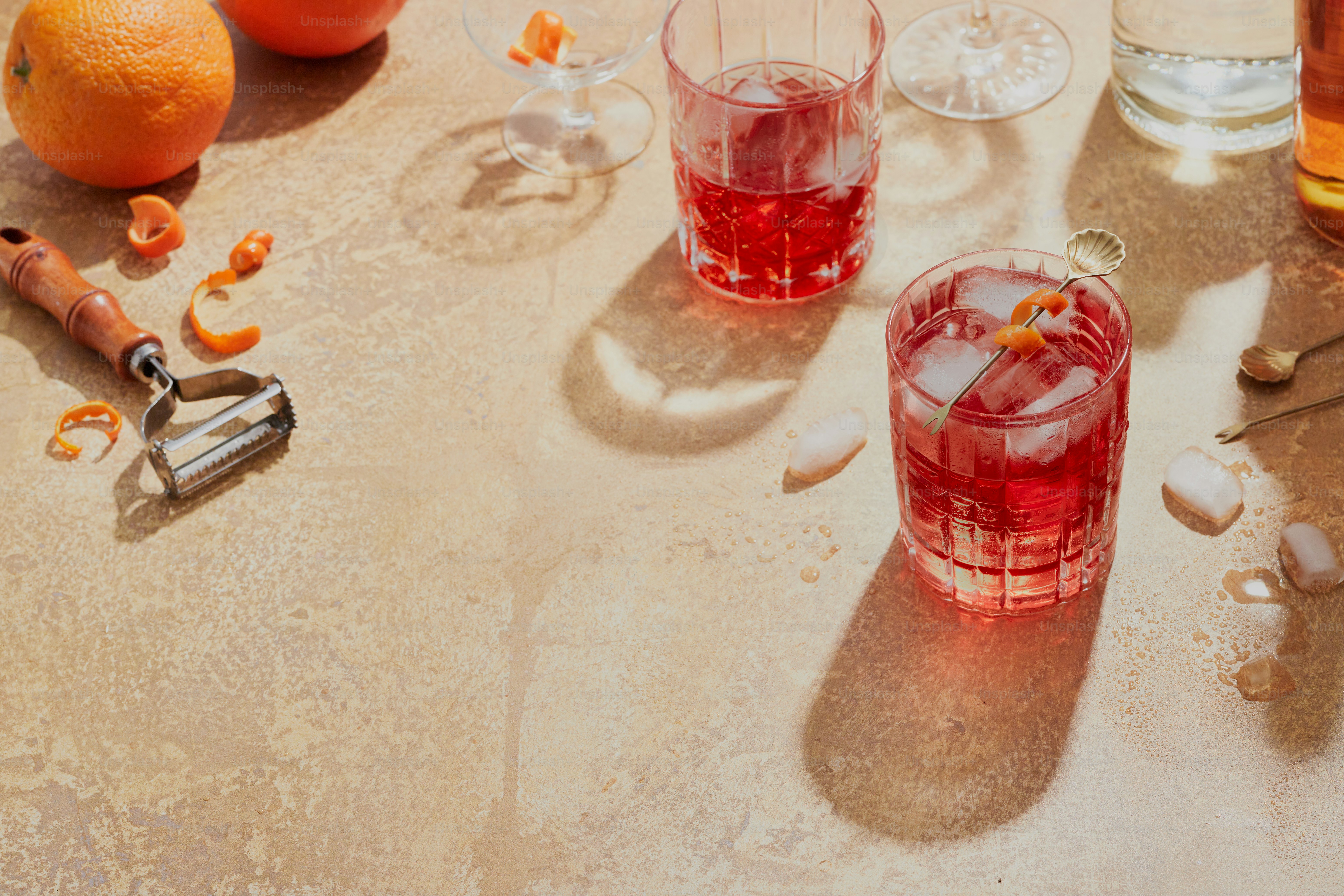 A table topped with glasses filled with liquid