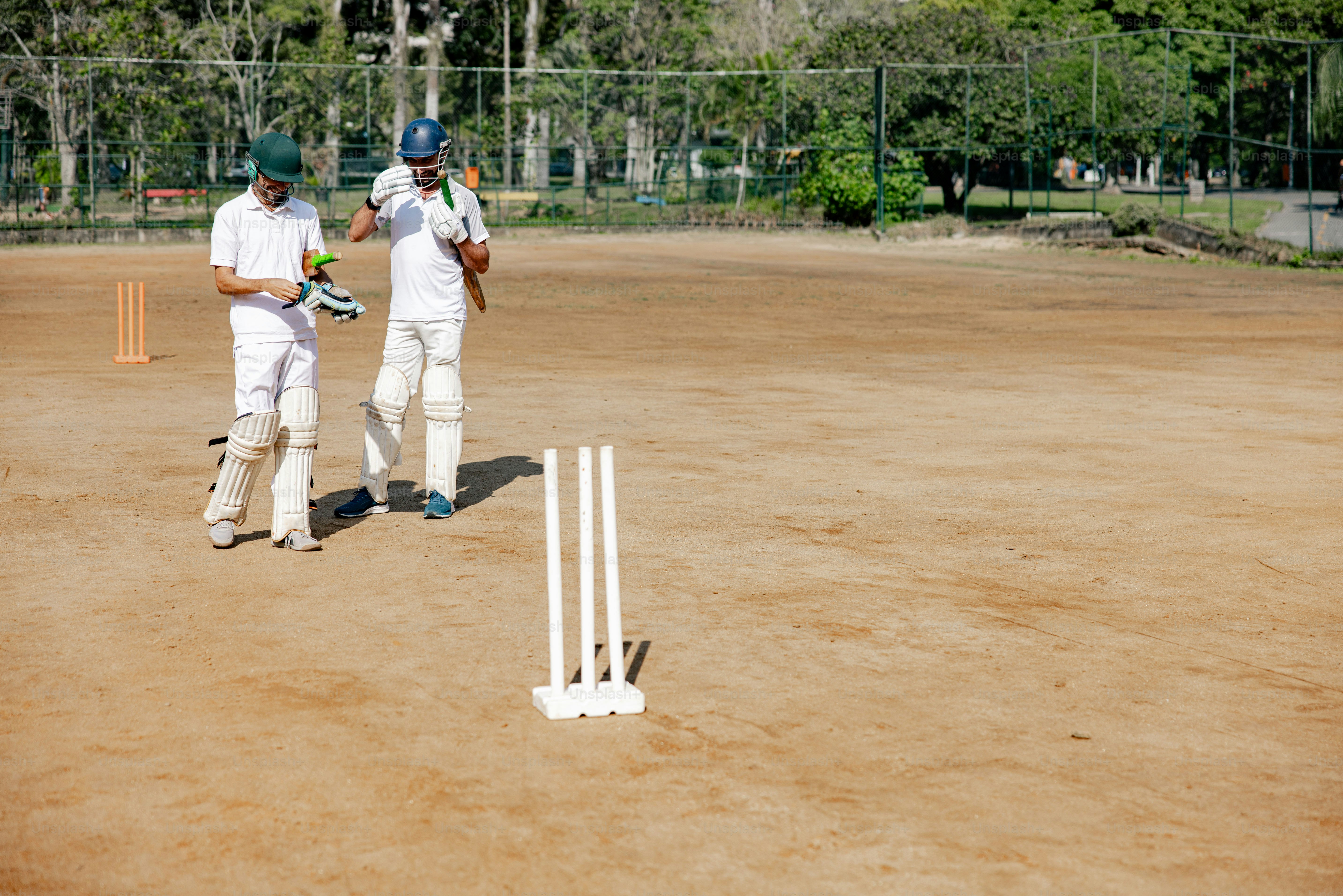 A couple of men standing next to each other on a field