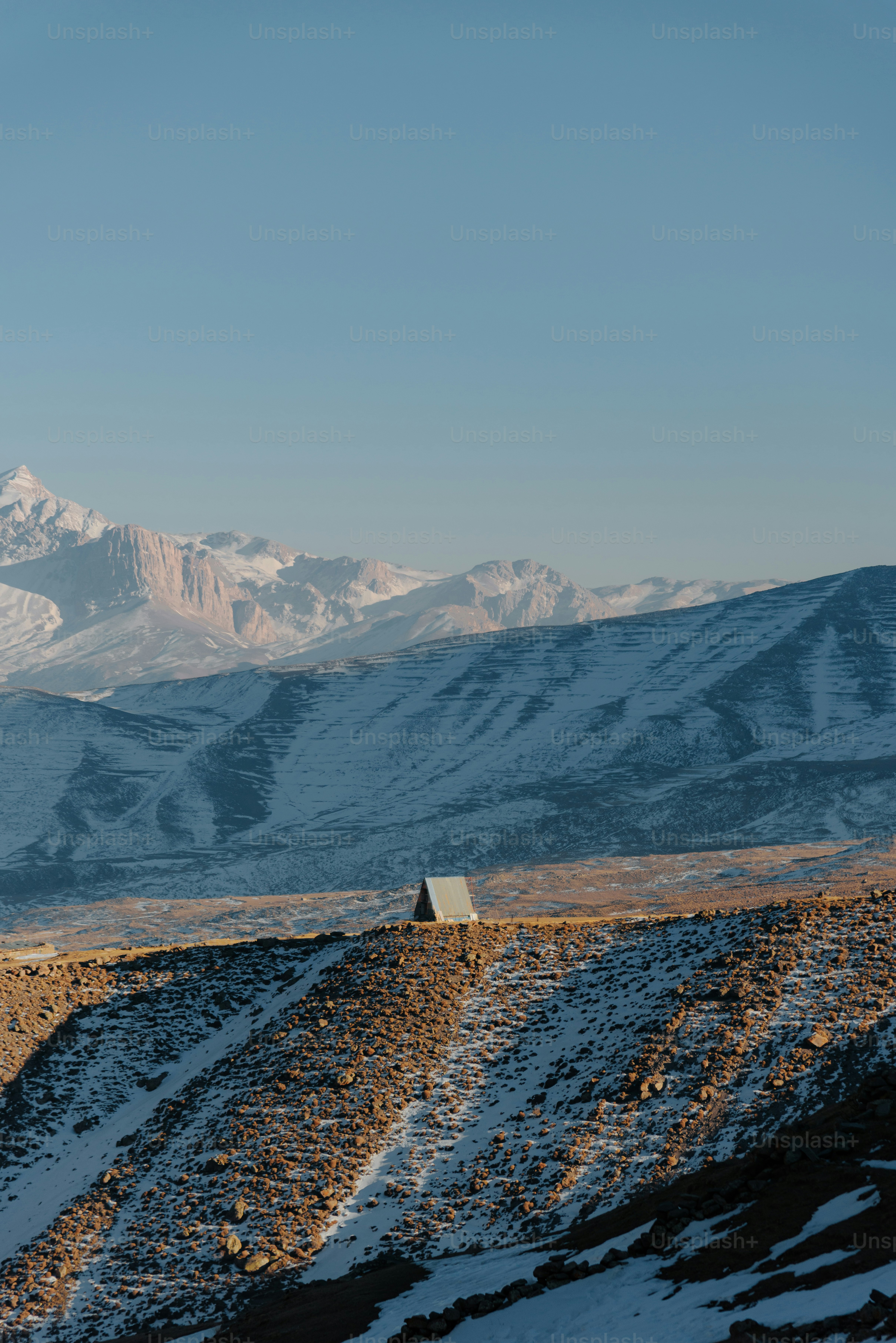 A man riding a snowboard down a snow covered slope