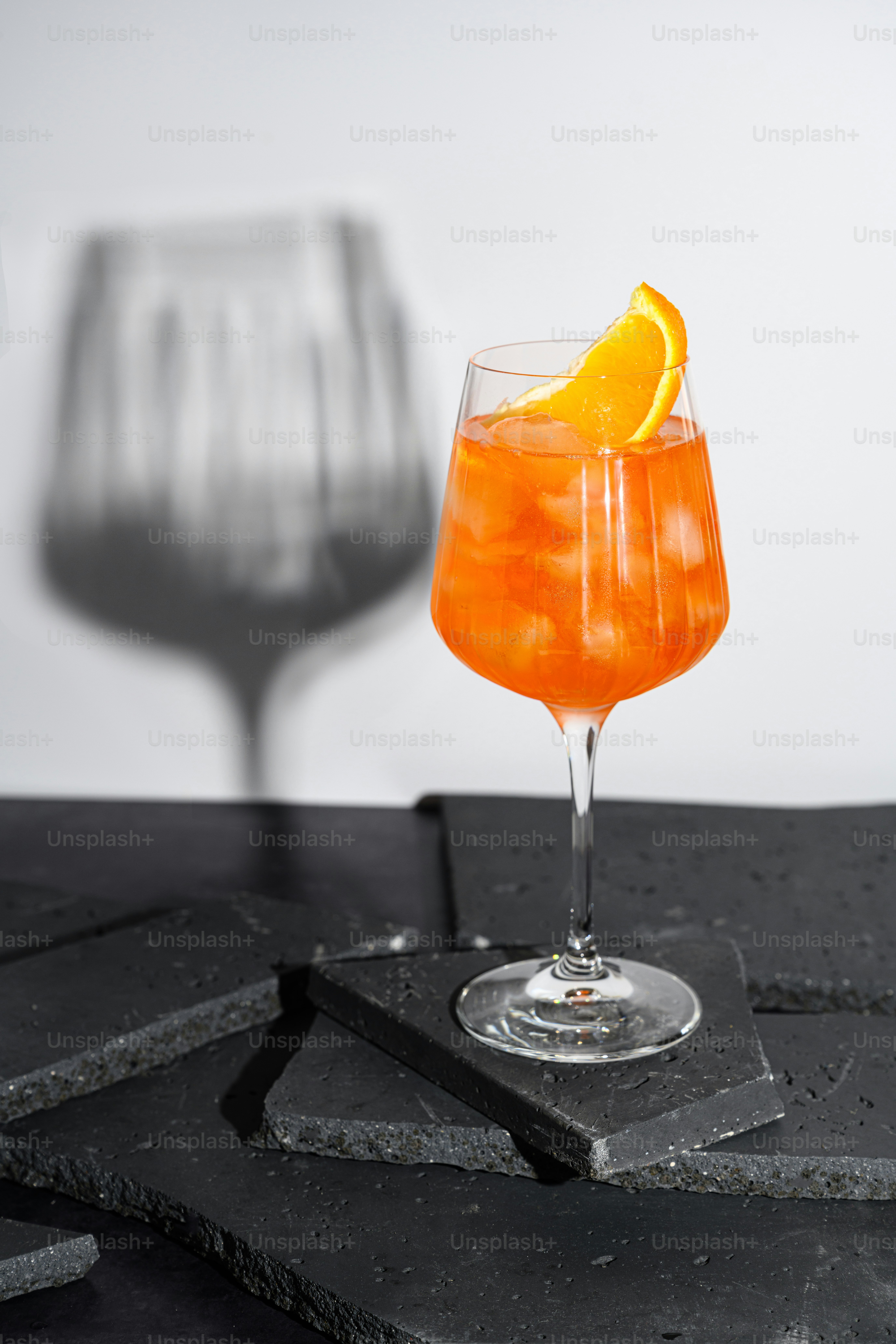 A glass of orange juice with a slice of orange