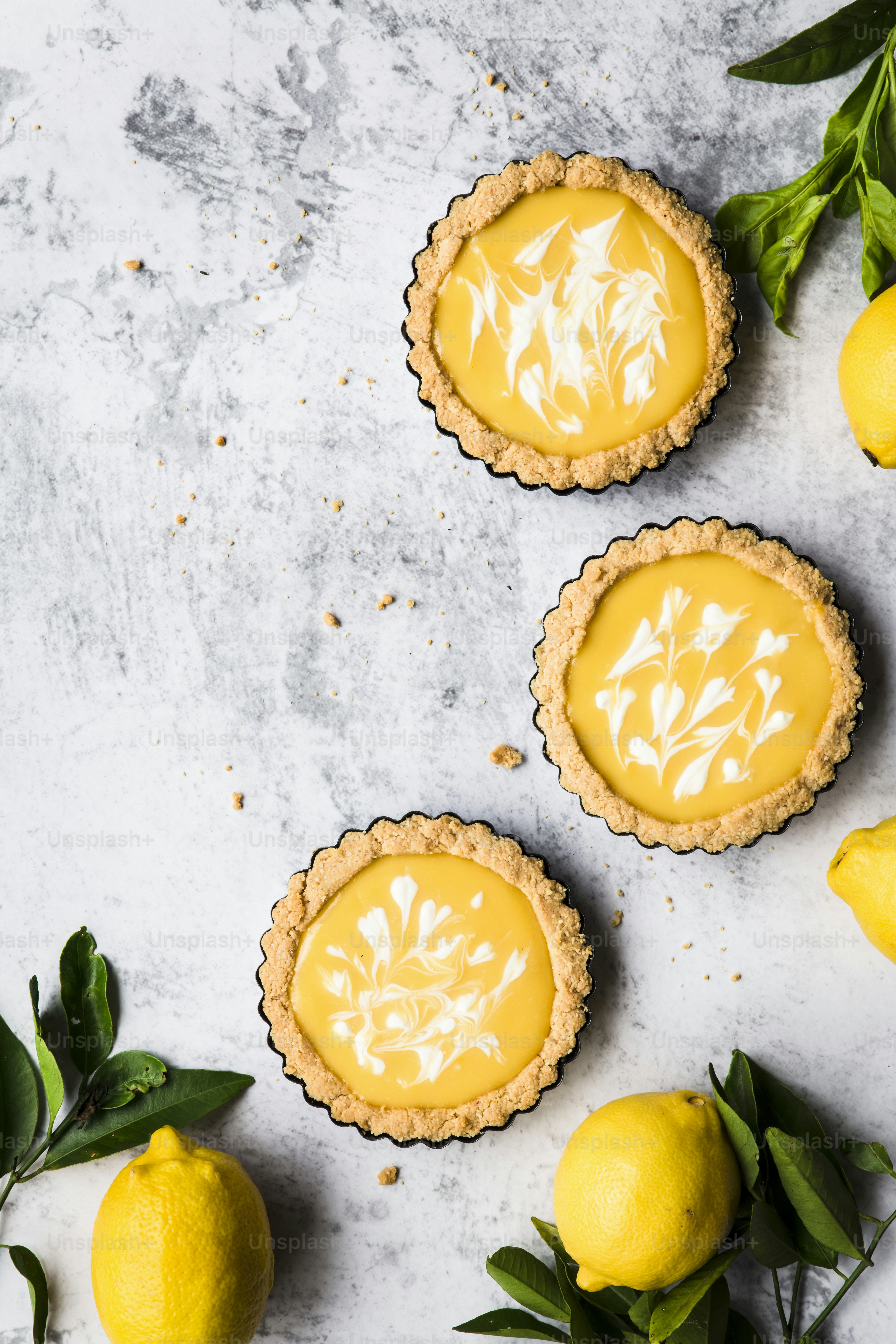 Three lemon tarts sitting on top of a table