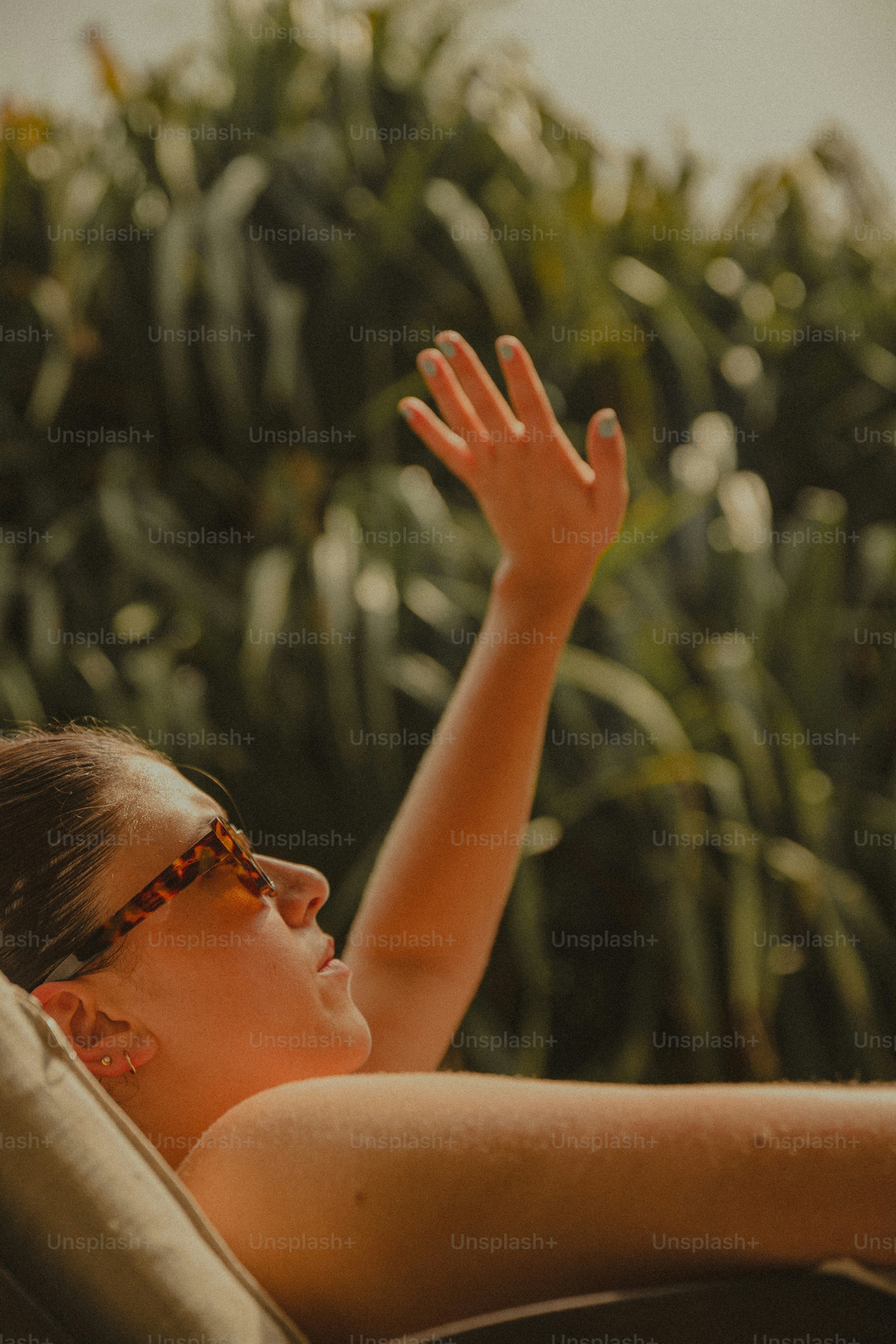 A woman in a chair with her hand up in the air