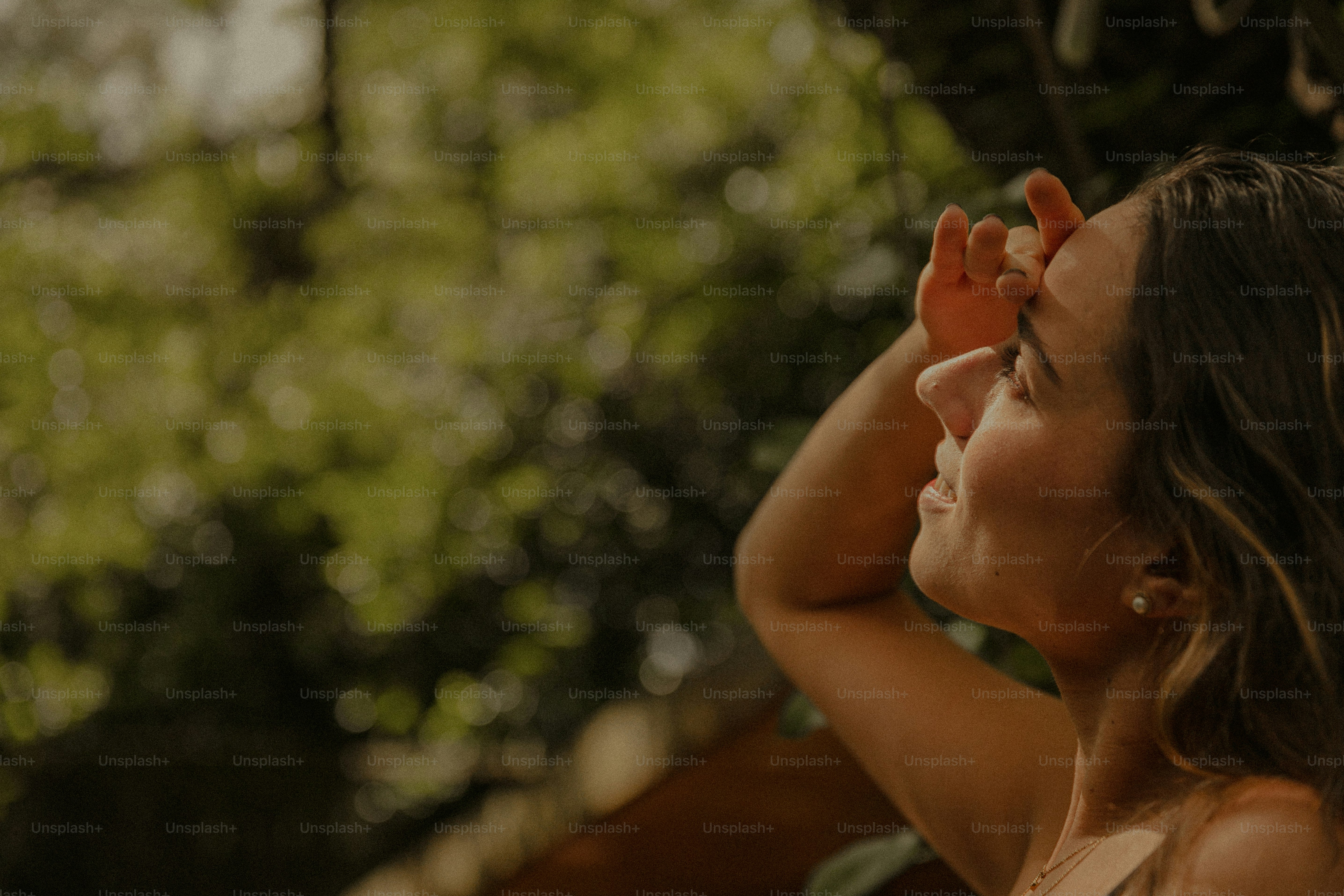 A woman holding an orange object up to her face