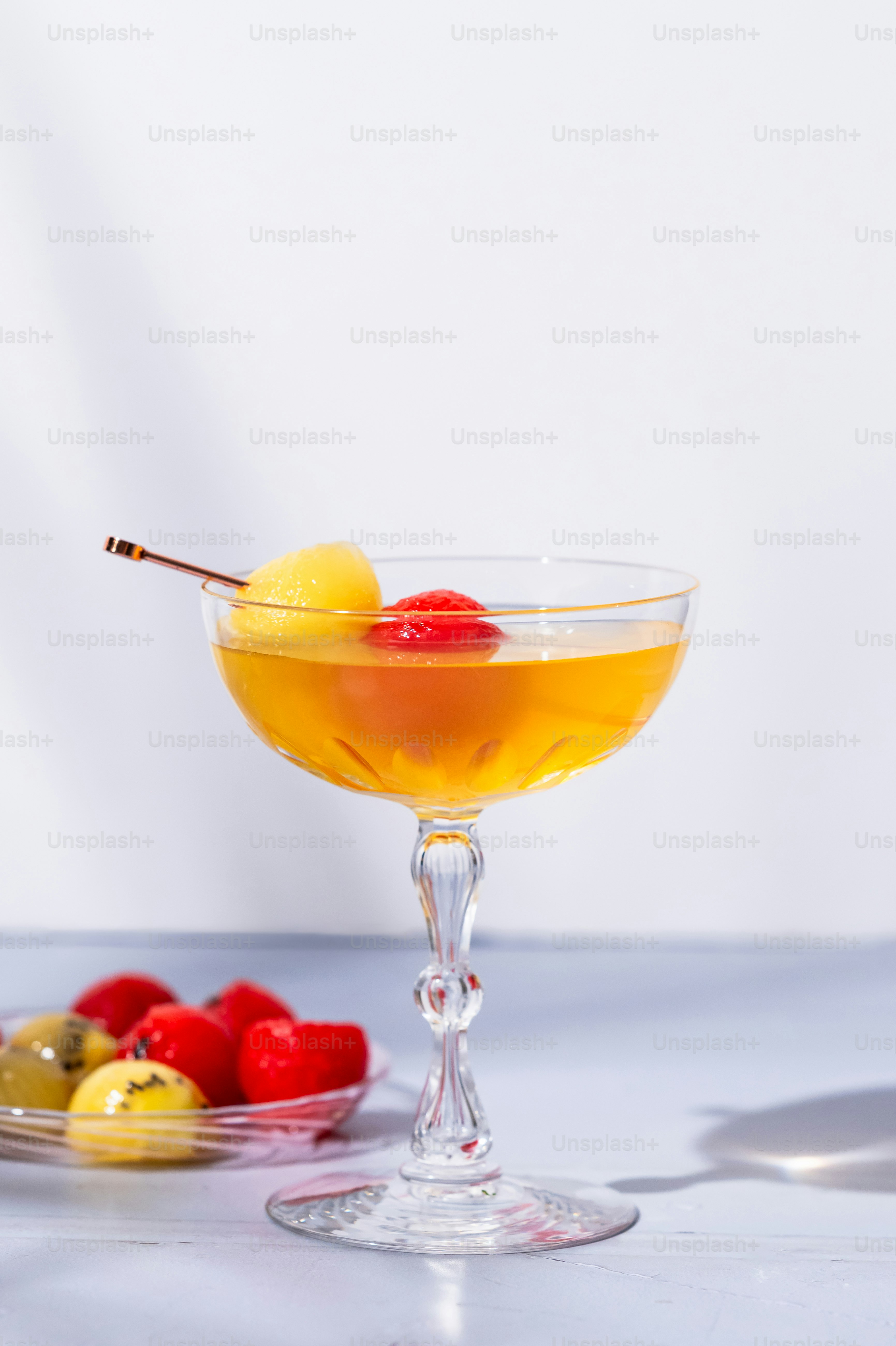 A bowl of fruit and a glass of wine