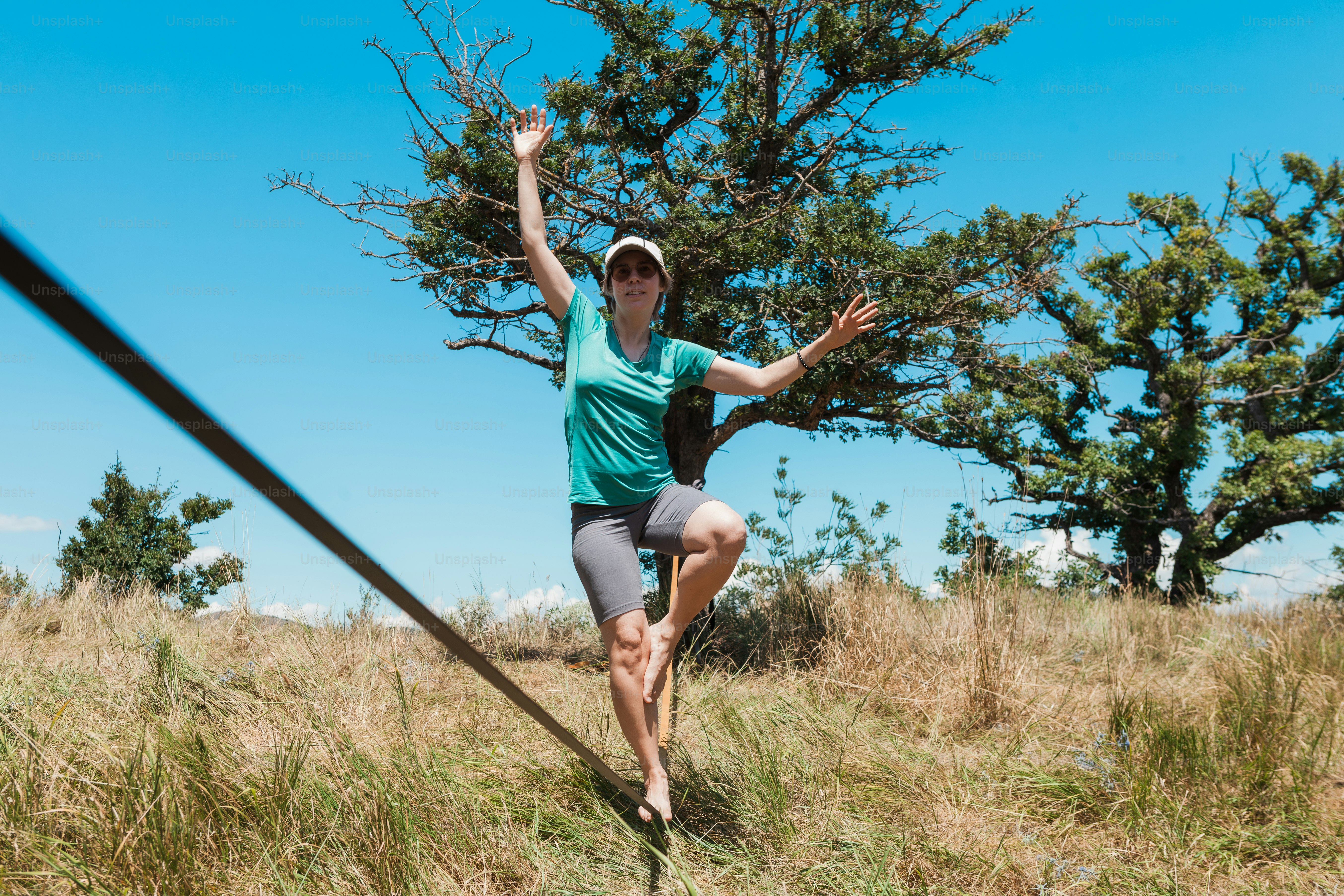 A woman in a green shirt is running in a field