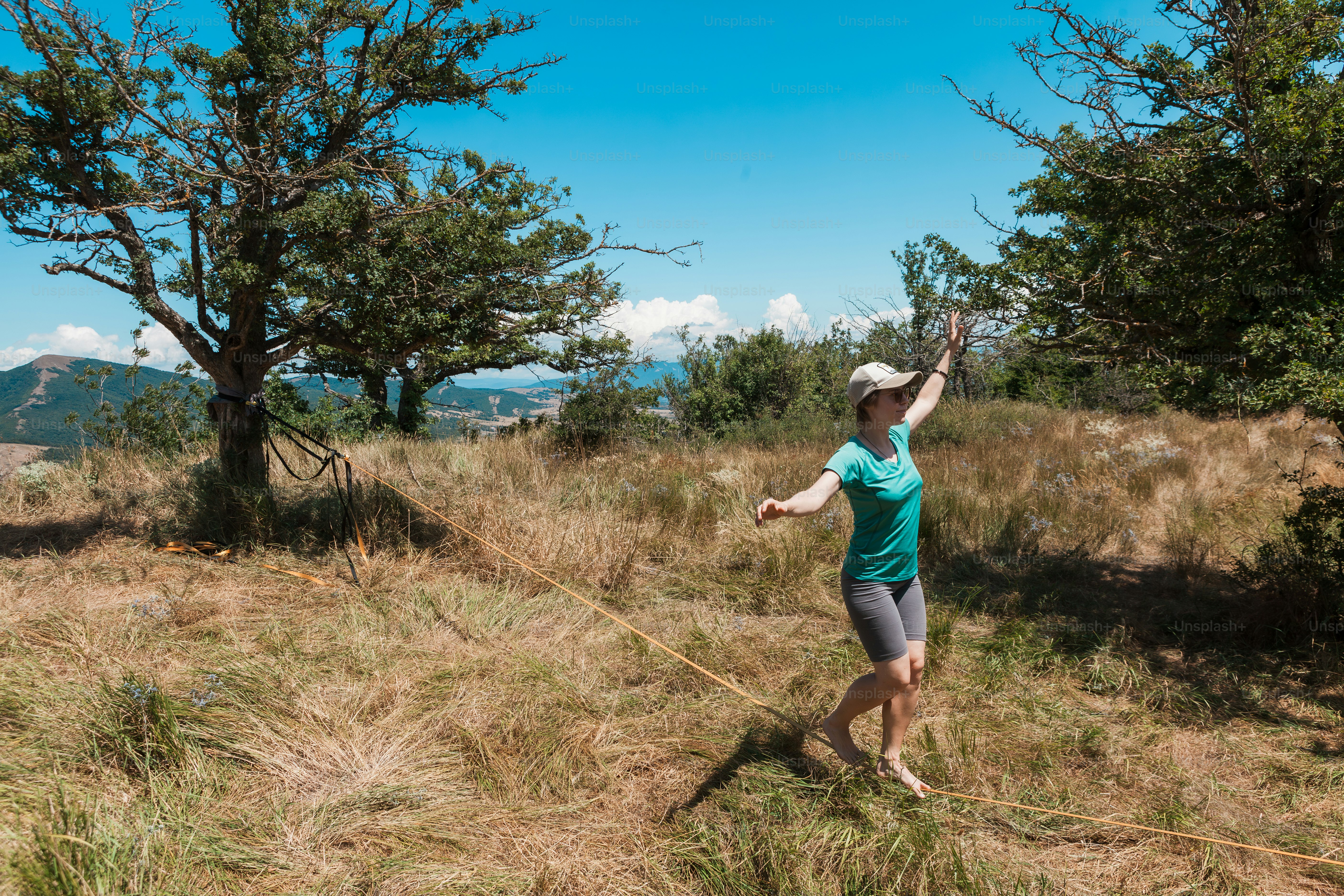A woman walking through a grass covered field
