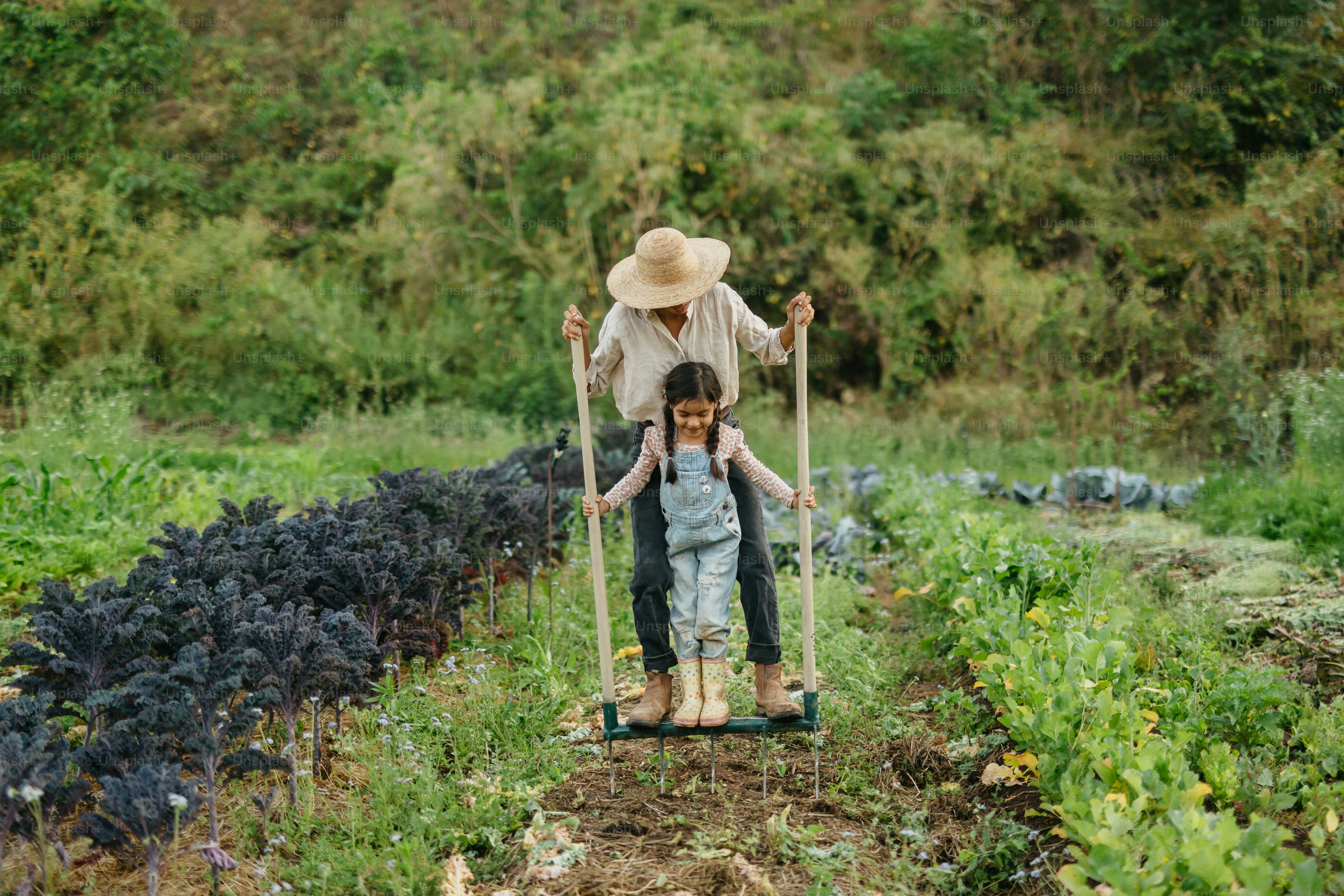 A man pushing a child in a wheelbarrow