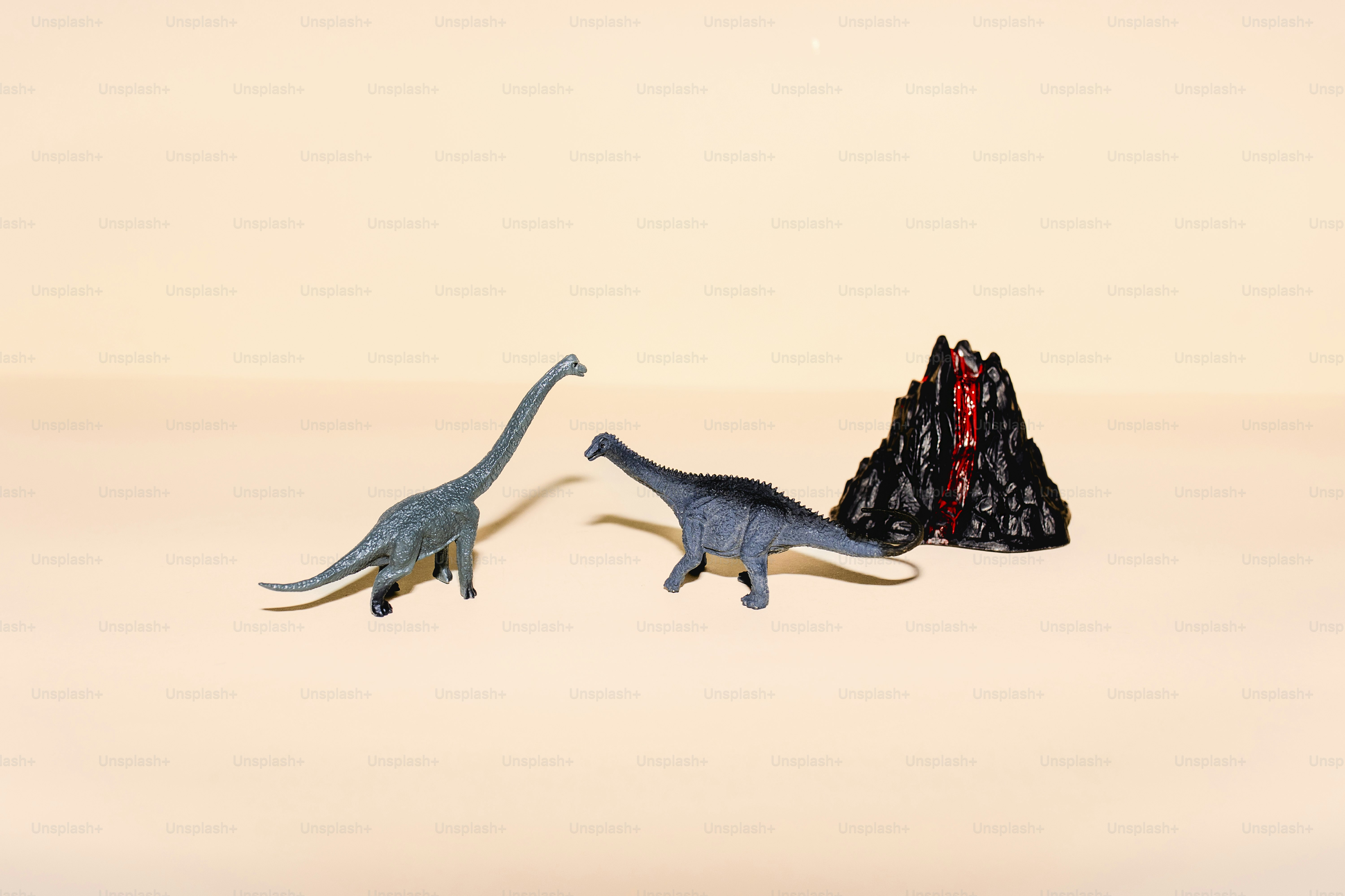 A couple of dinosaurs that are standing next to each other