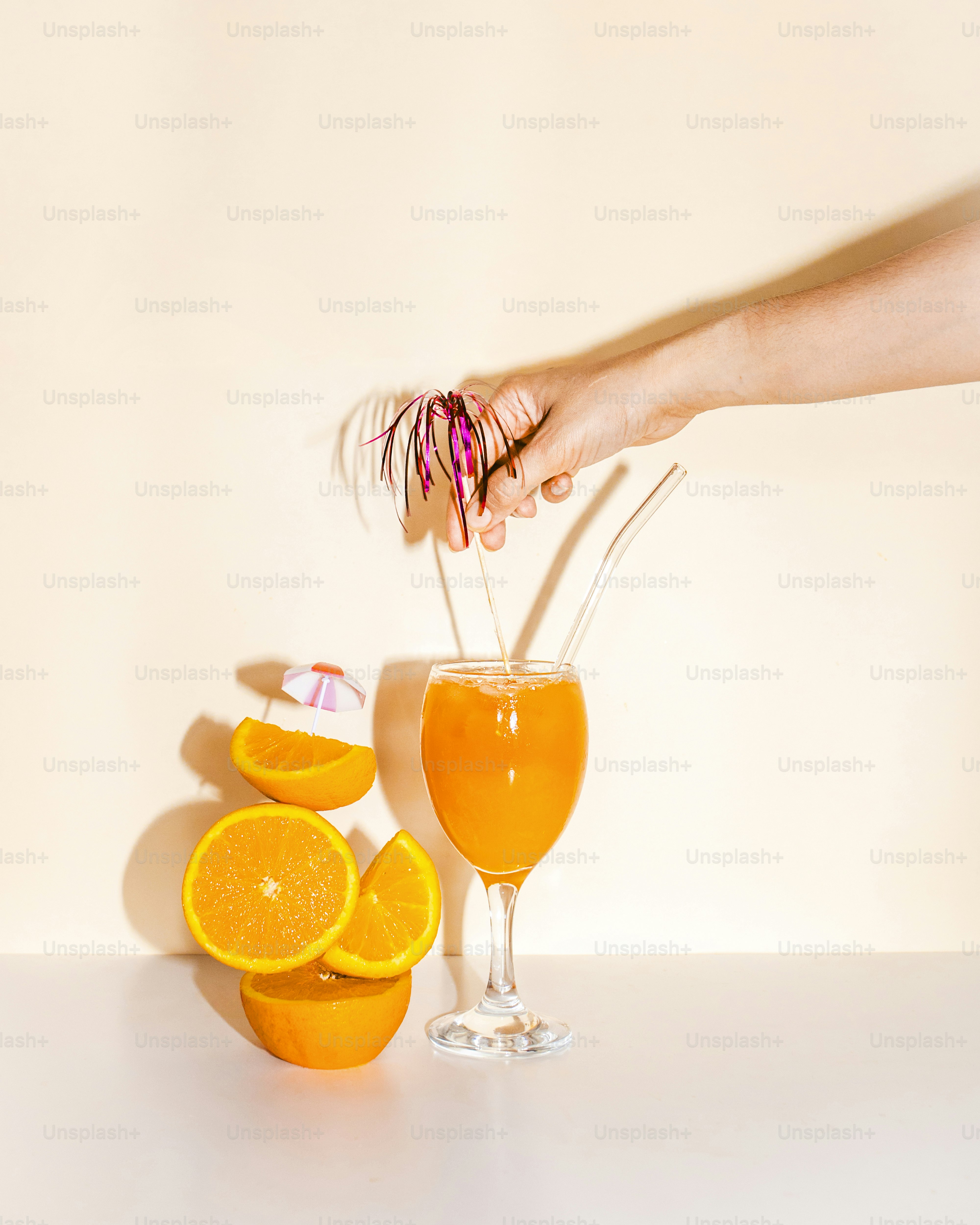 A person is squeezing orange juice into a glass