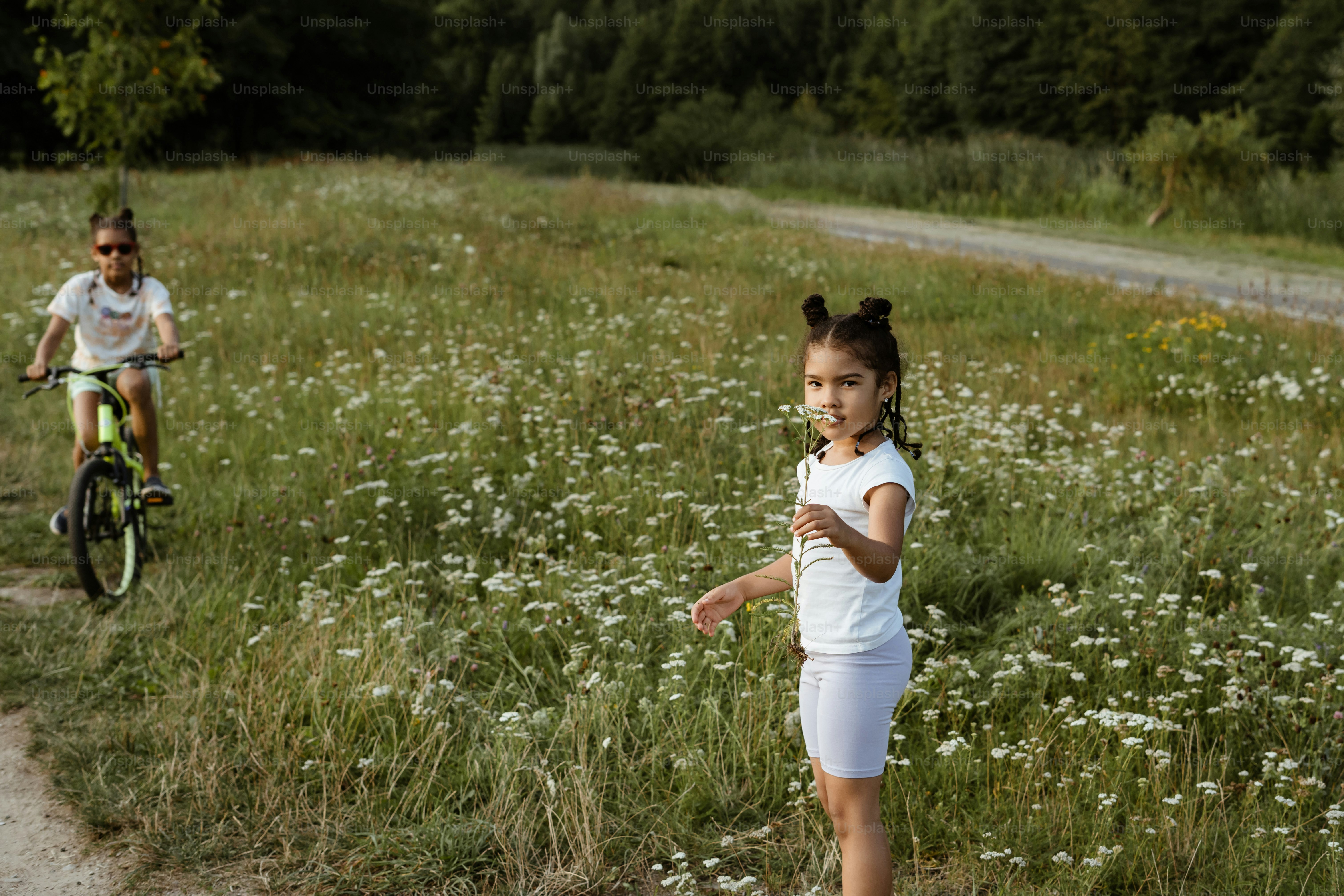 A couple of kids riding bikes down a dirt road