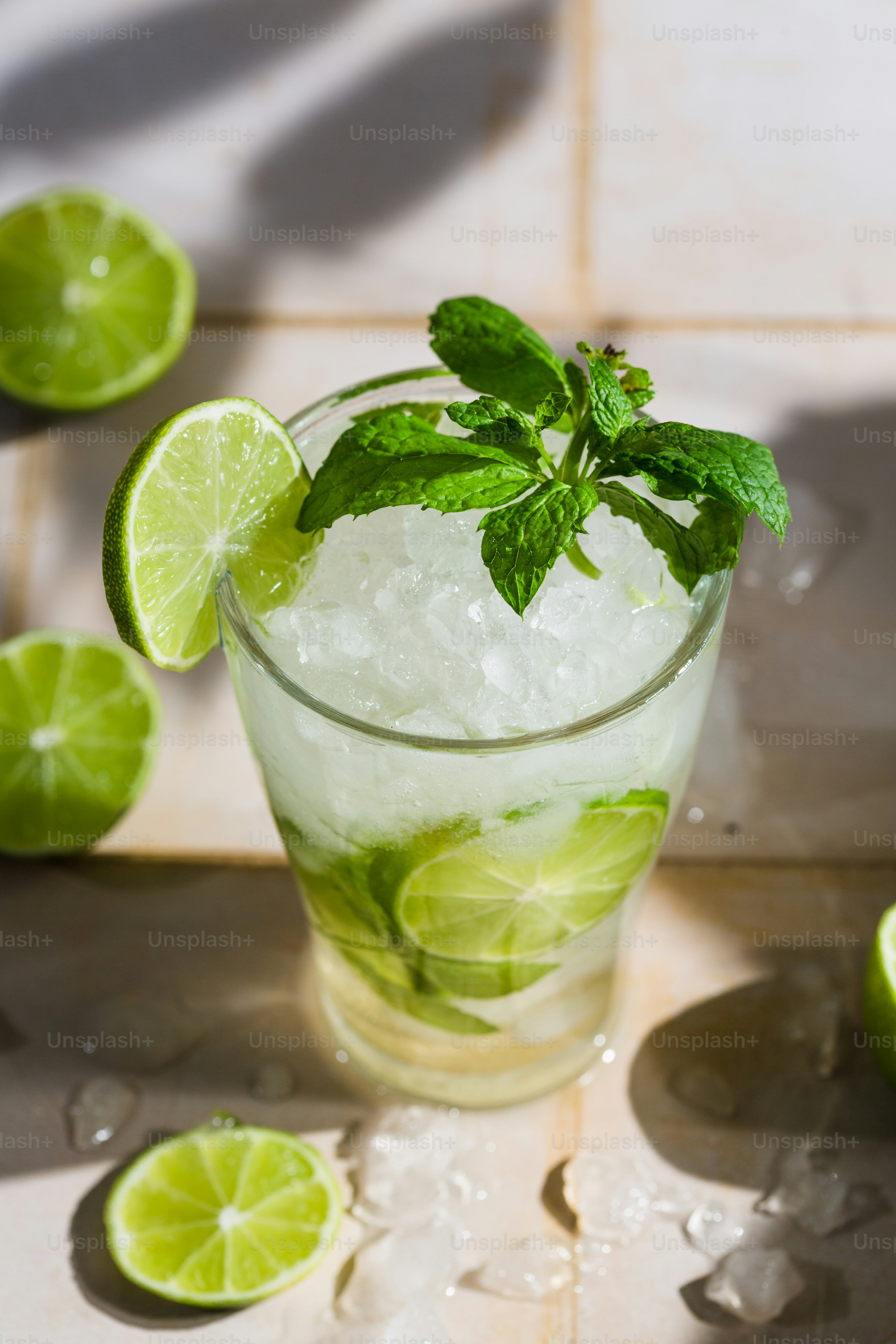 A glass filled with ice and lime slices