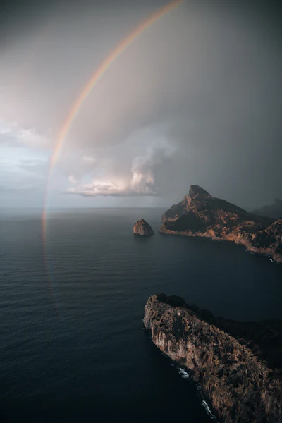 Rainbow over body of water